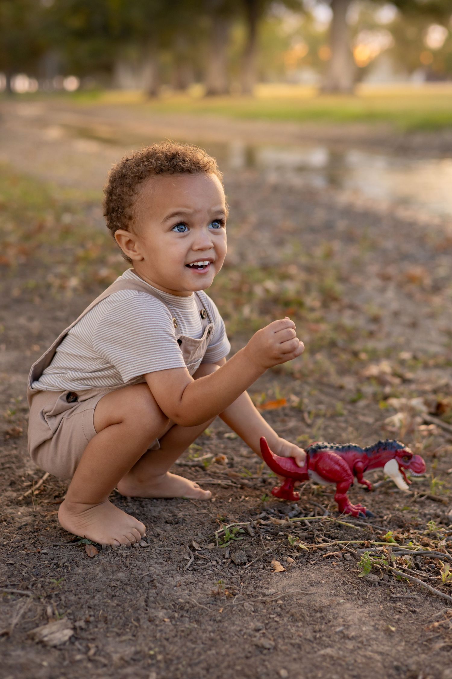 Family Session photography photographer Cleveland Mississippi Country creek pond boy playing with his toys