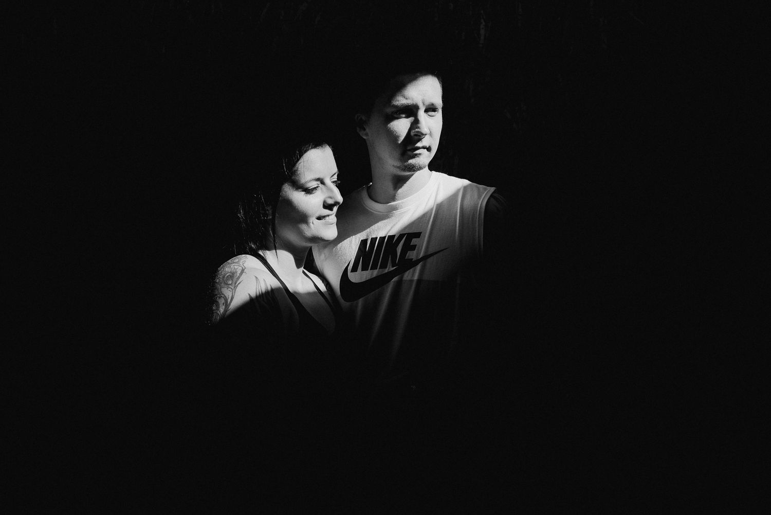 Intimate black and white portrait in dramatic lighting.