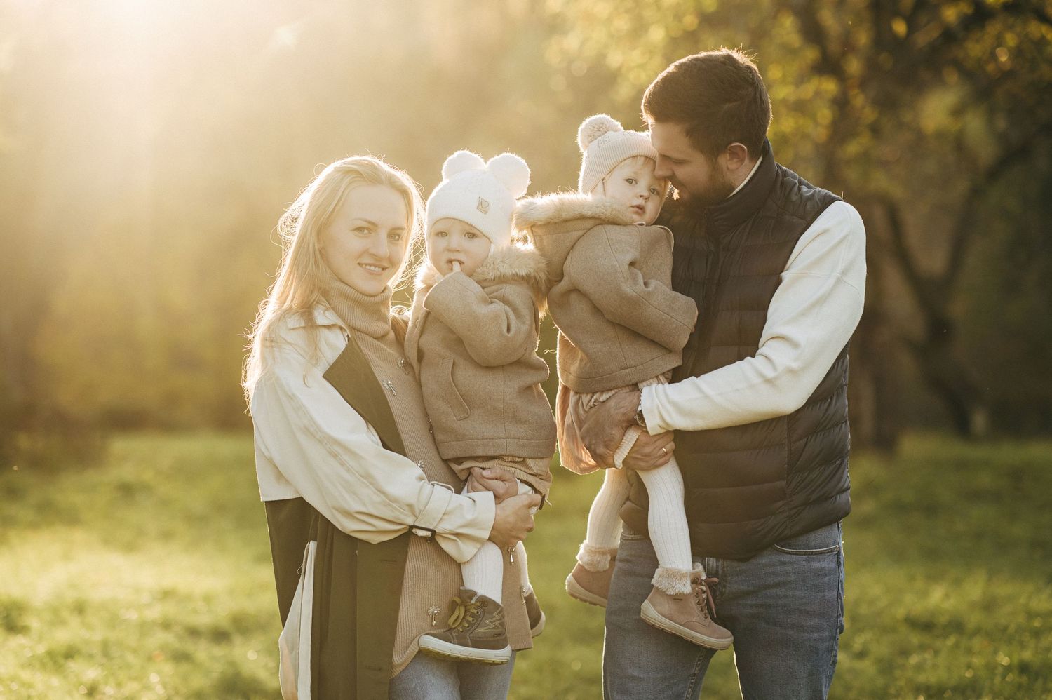 Family enjoying outdoor moments together in warm sunset light.
