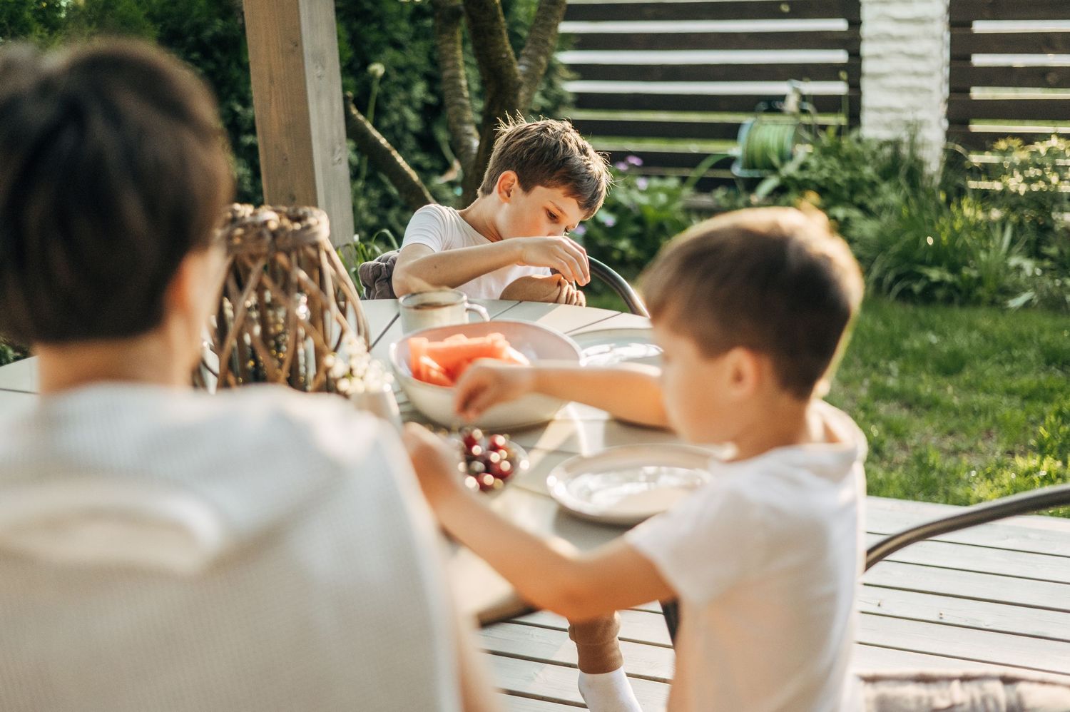 Candid outdoor meal sharing sequence on wooden deck.