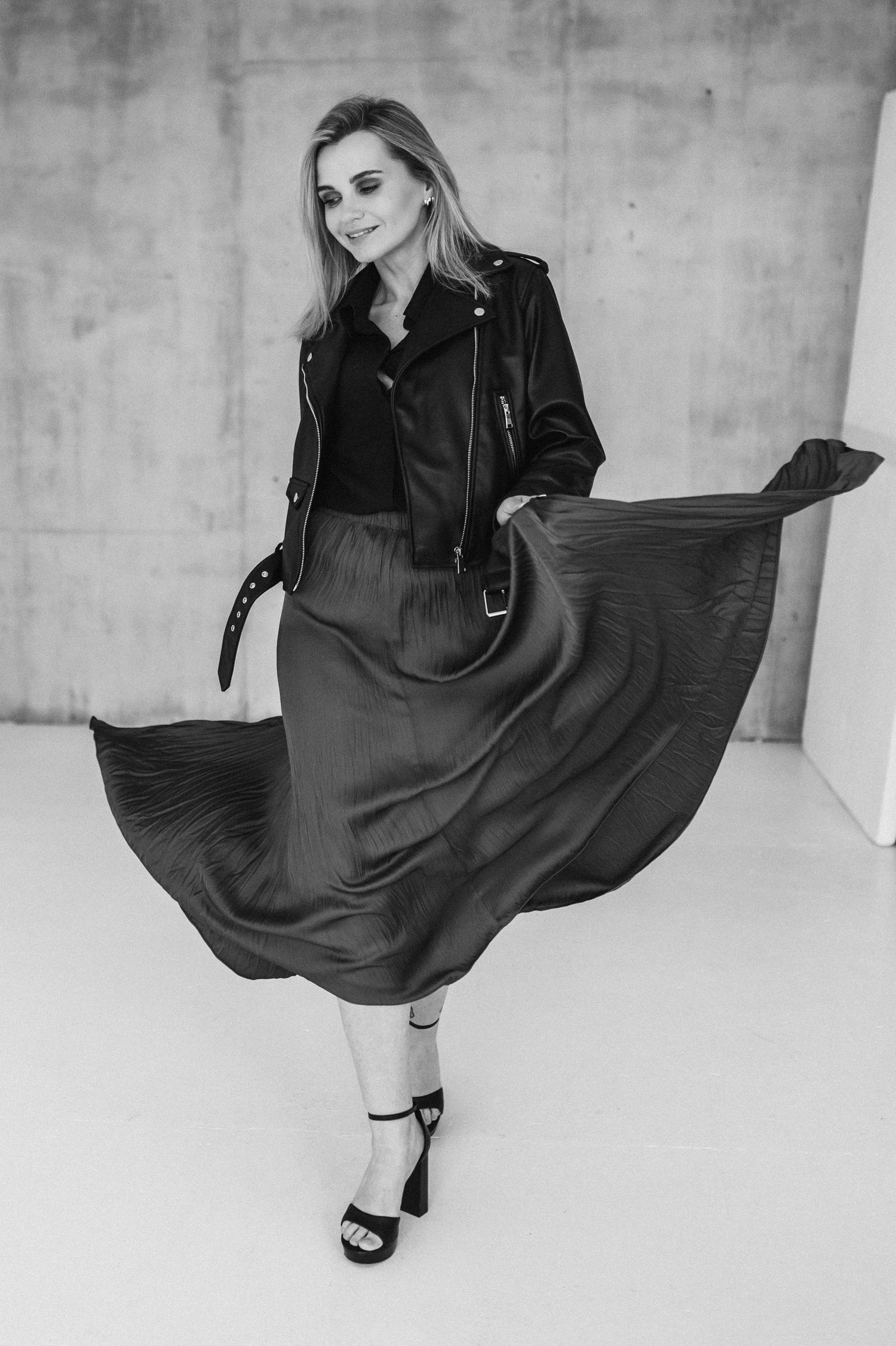 Black and white fashion series with flowing dress and dramatic movement.