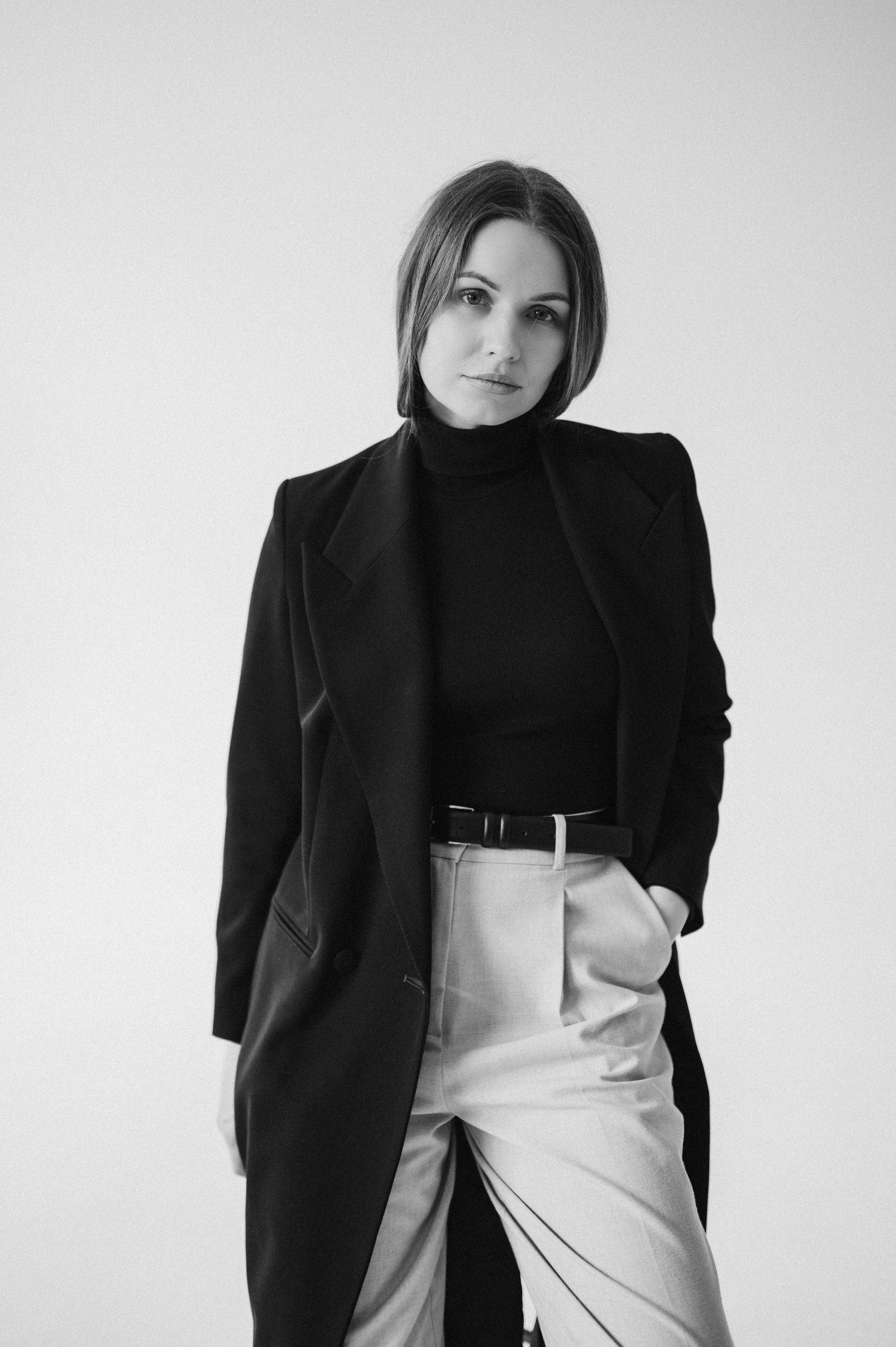 Minimalist black and white fashion portrait series showcasing a blazer and high-waisted pants.