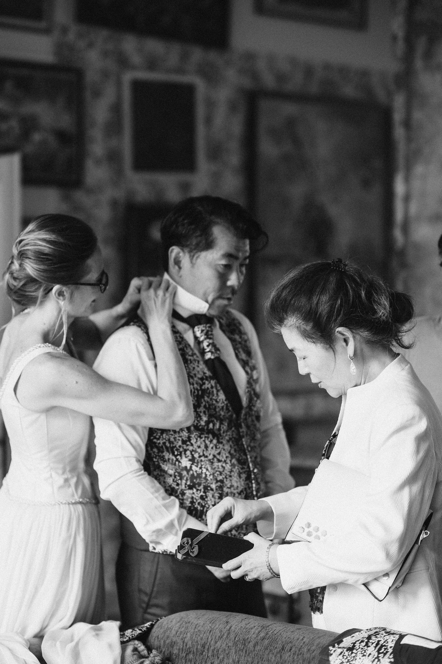 Black and white photos of wedding preparation moments and final touches.