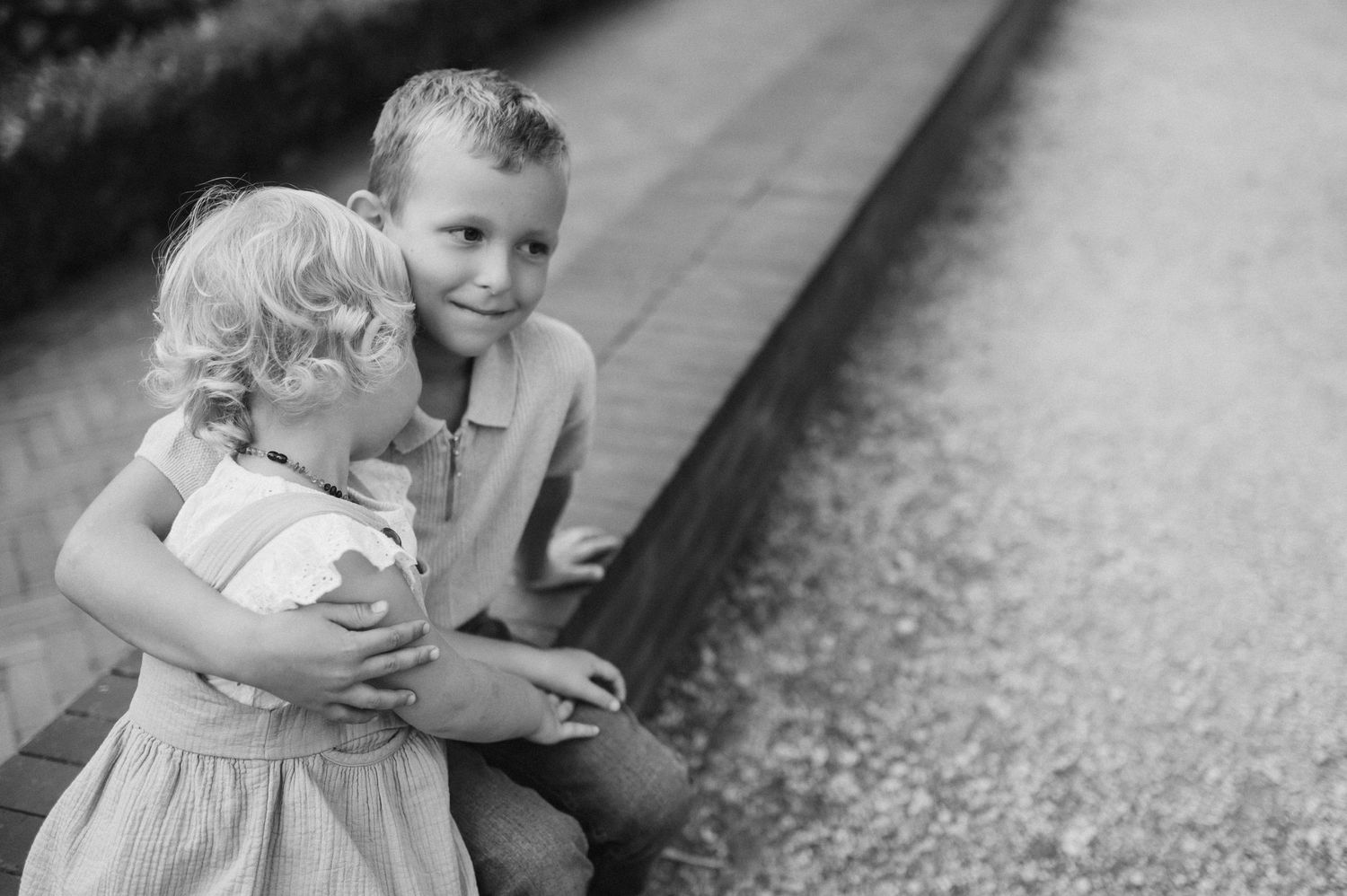 Black and white photo sequence showing tender family interactions on a path.