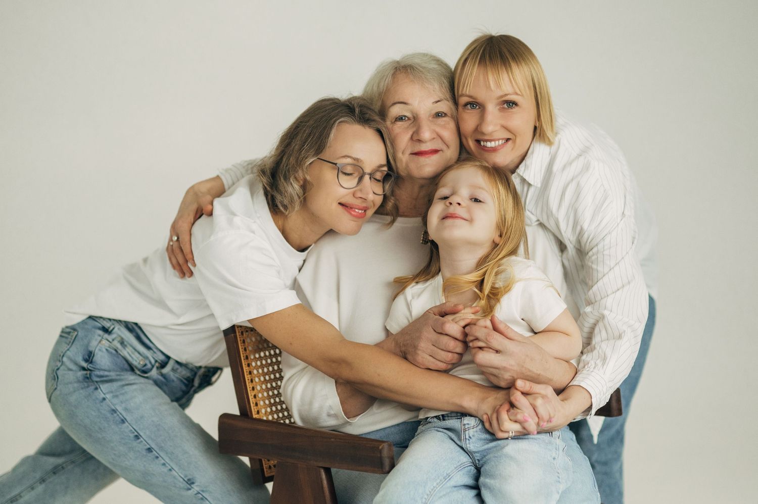 A series of intimate family portraits showing tender moments between parents and children in soft, neutral tones.