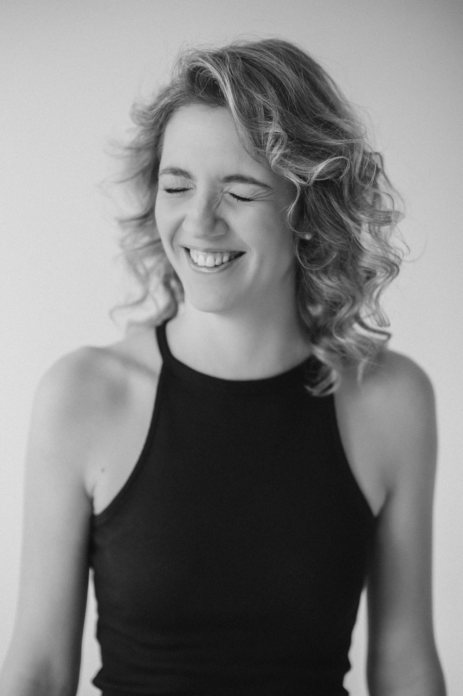 Black and white photo sequence of joyful expressions and natural laughter.