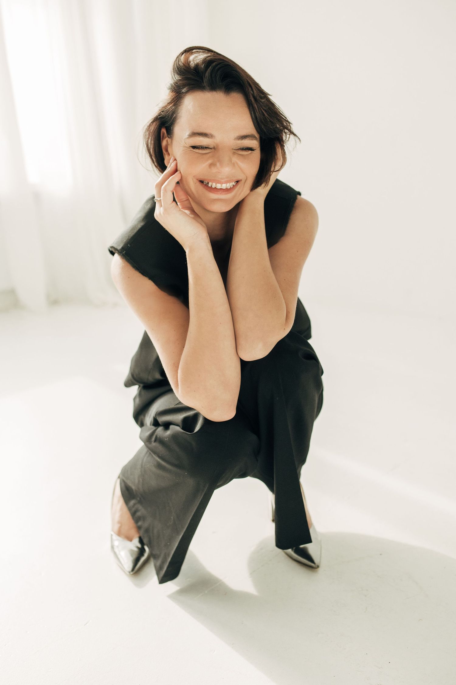 Candid style portraits showing joyful expressions in bright white studio setting.
