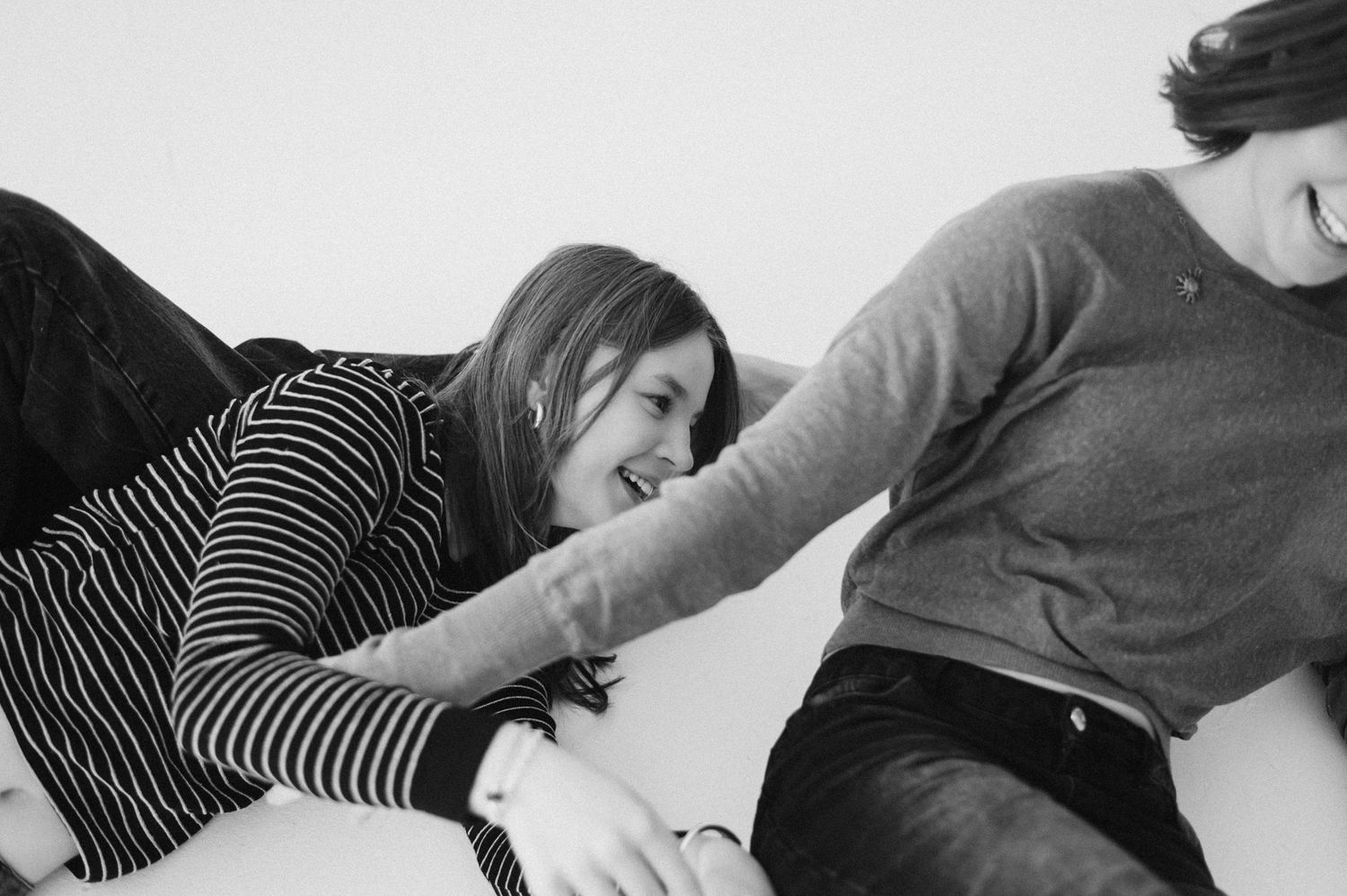 Motion sequence of people lying down in casual poses against white background.