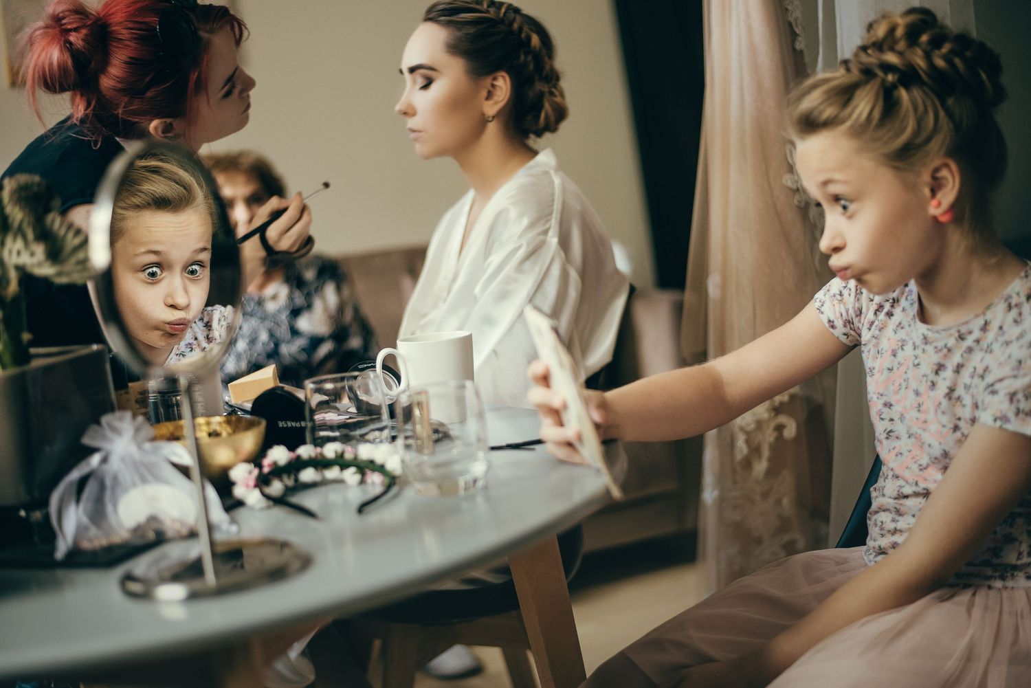 Wedding preparation scene showing close-up details of hair and makeup styling.