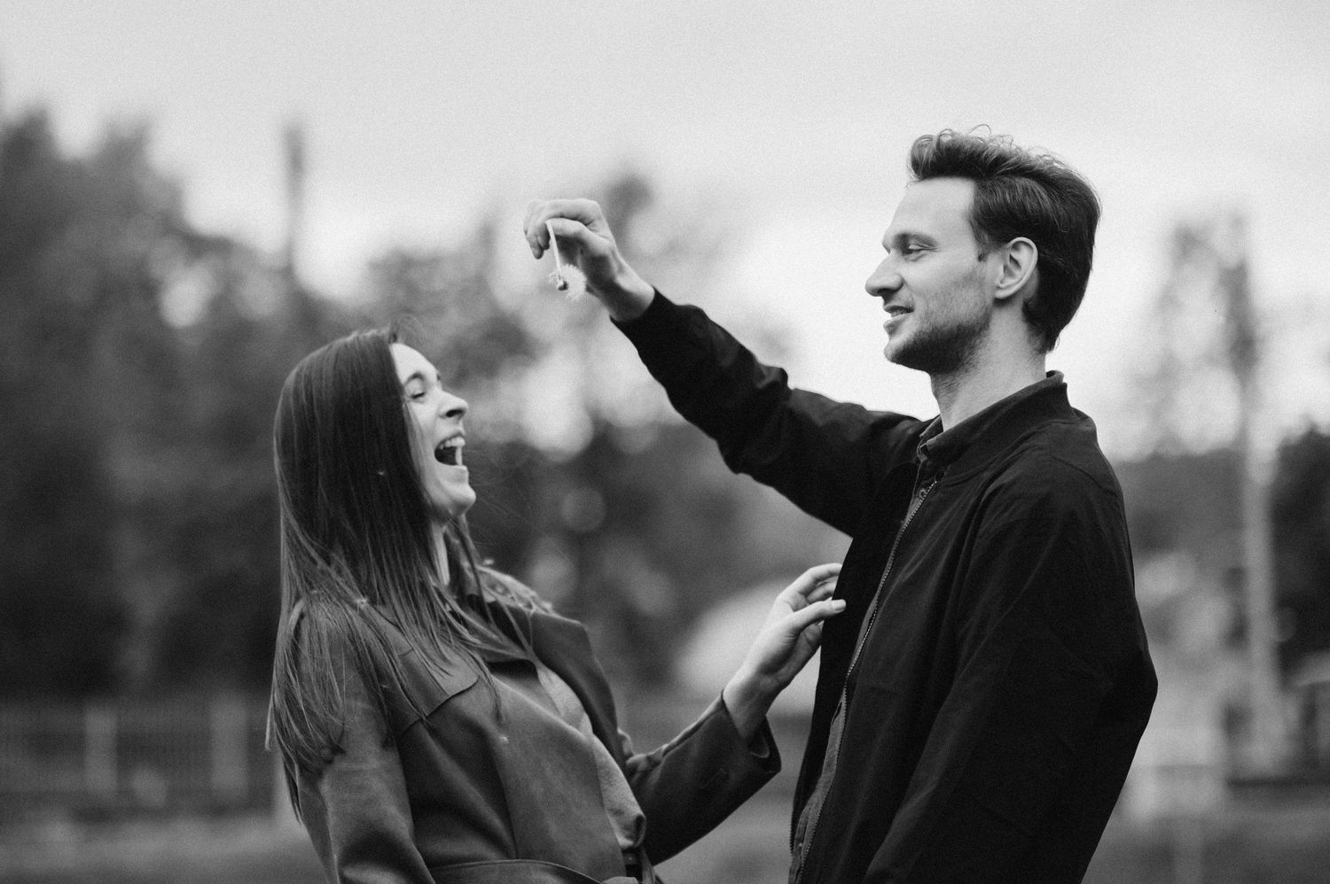 Couple dancing and twirling together in black and white photograph.