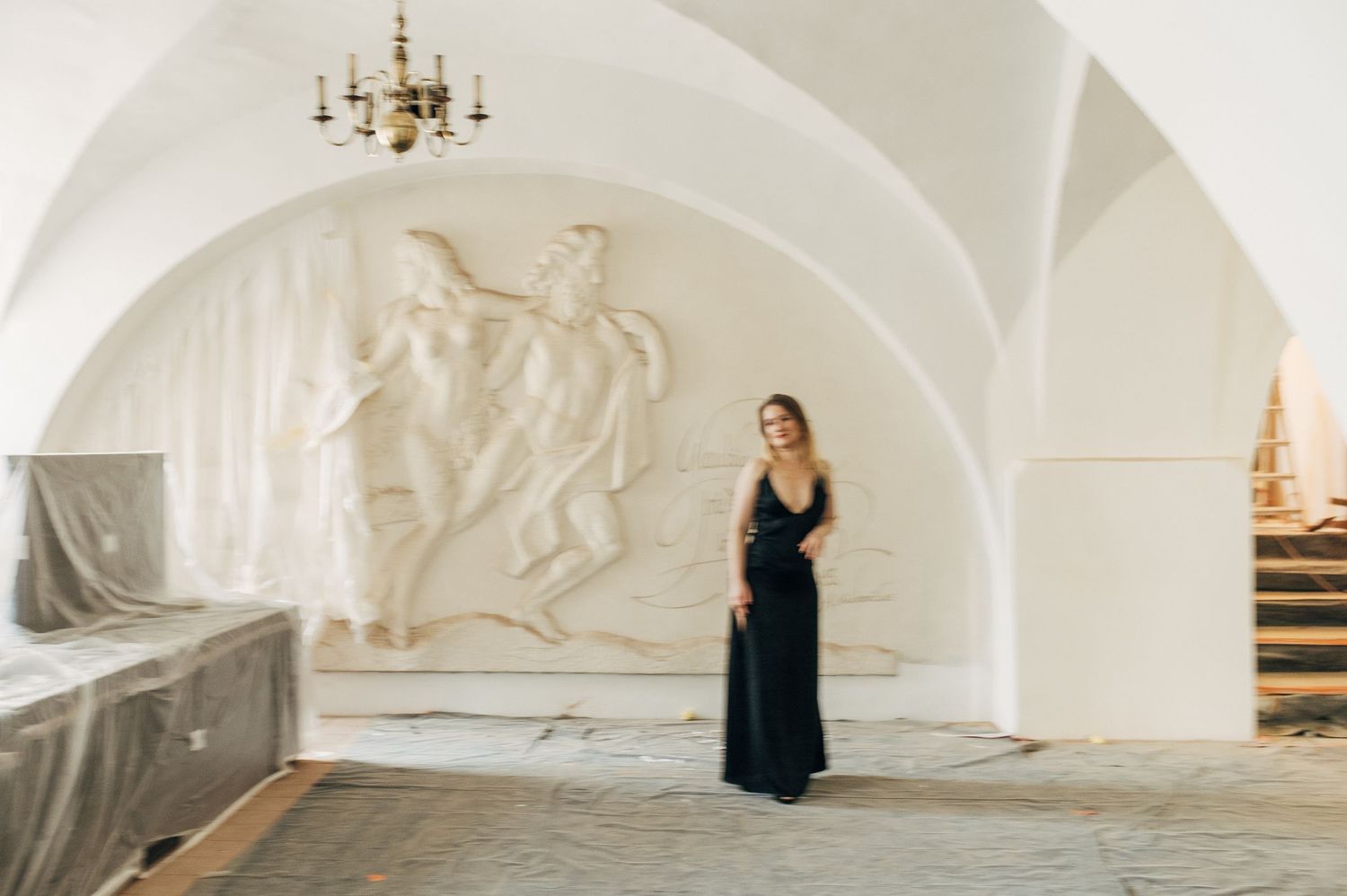 Graceful poses captured under white arched ceiling with classical details.
