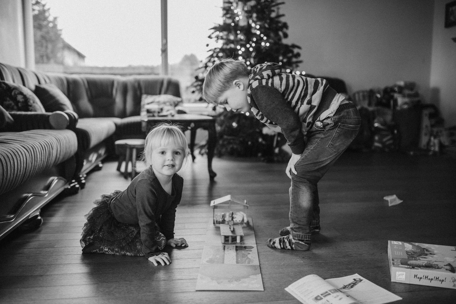 Black and white photo of yoga poses on hardwood floor.