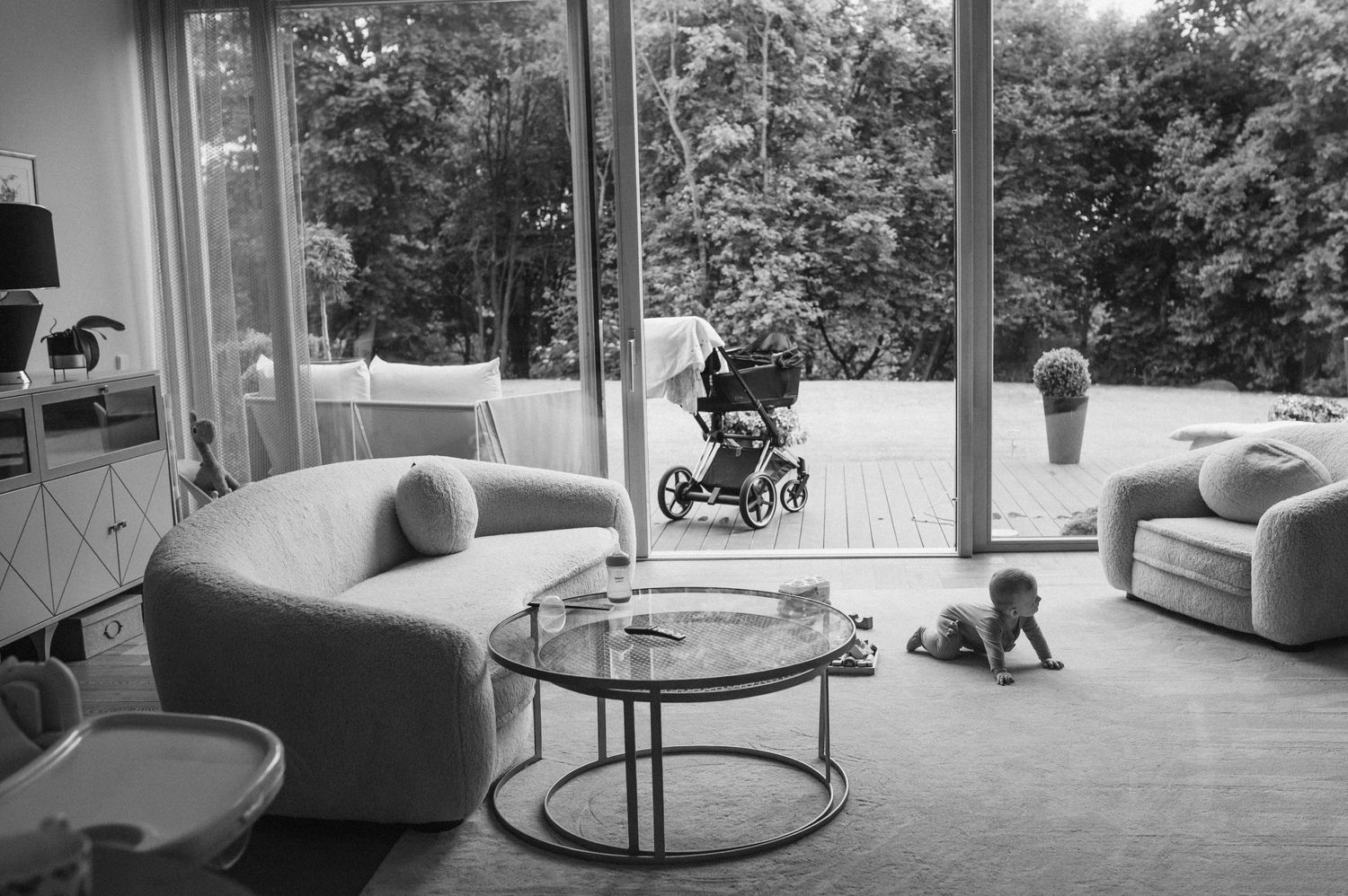 Modern living room interior with large windows and minimalist furniture.