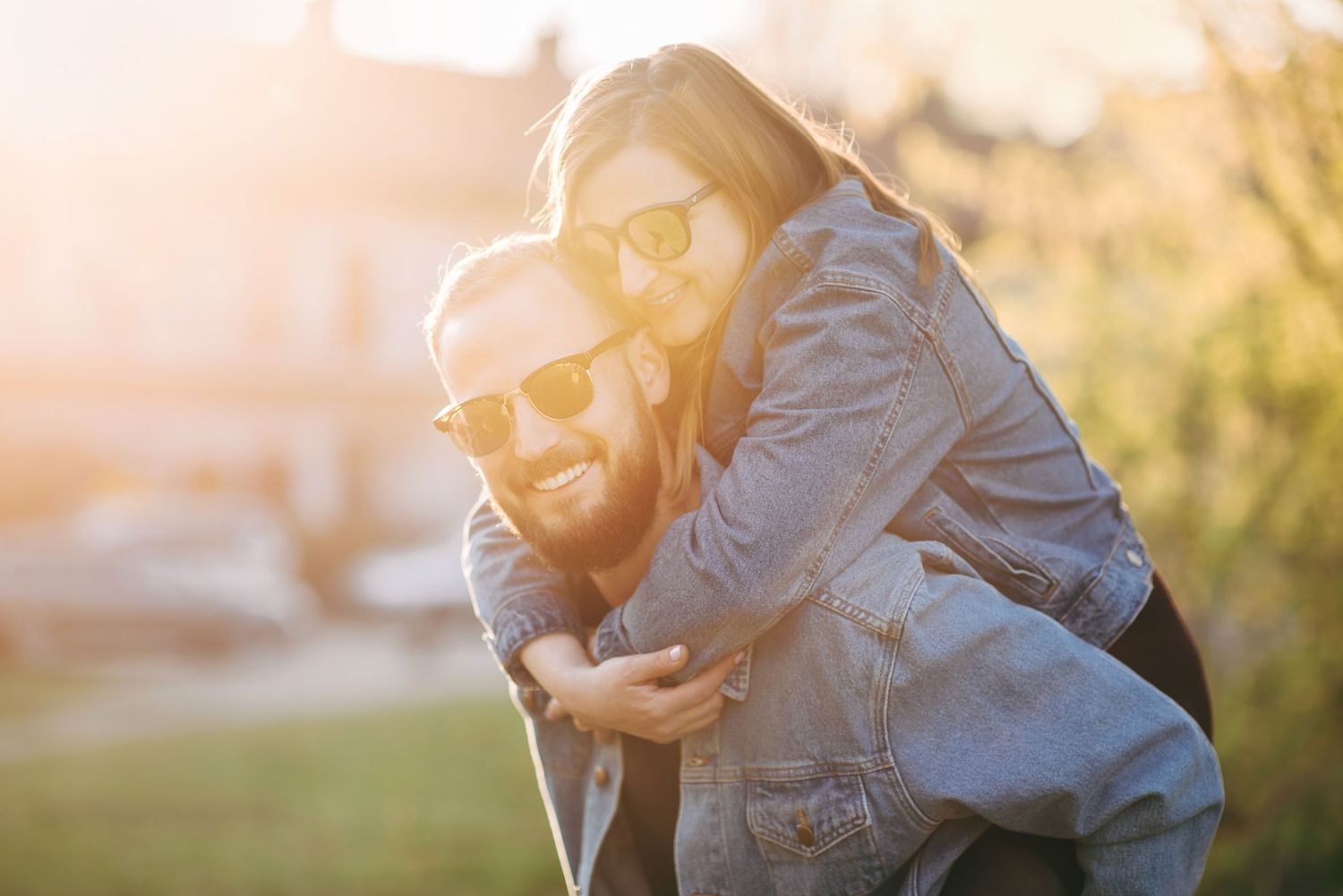 Golden sunlight illuminates a romantic outdoor engagement session.
