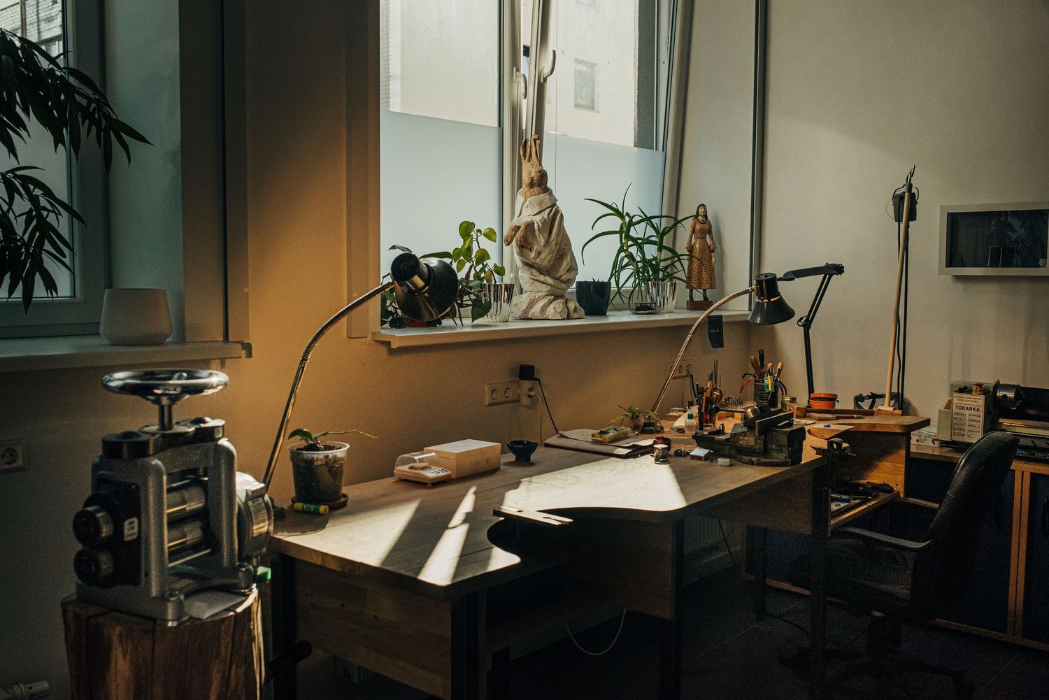 Interior view of a professional studio workspace with equipment and natural lighting.