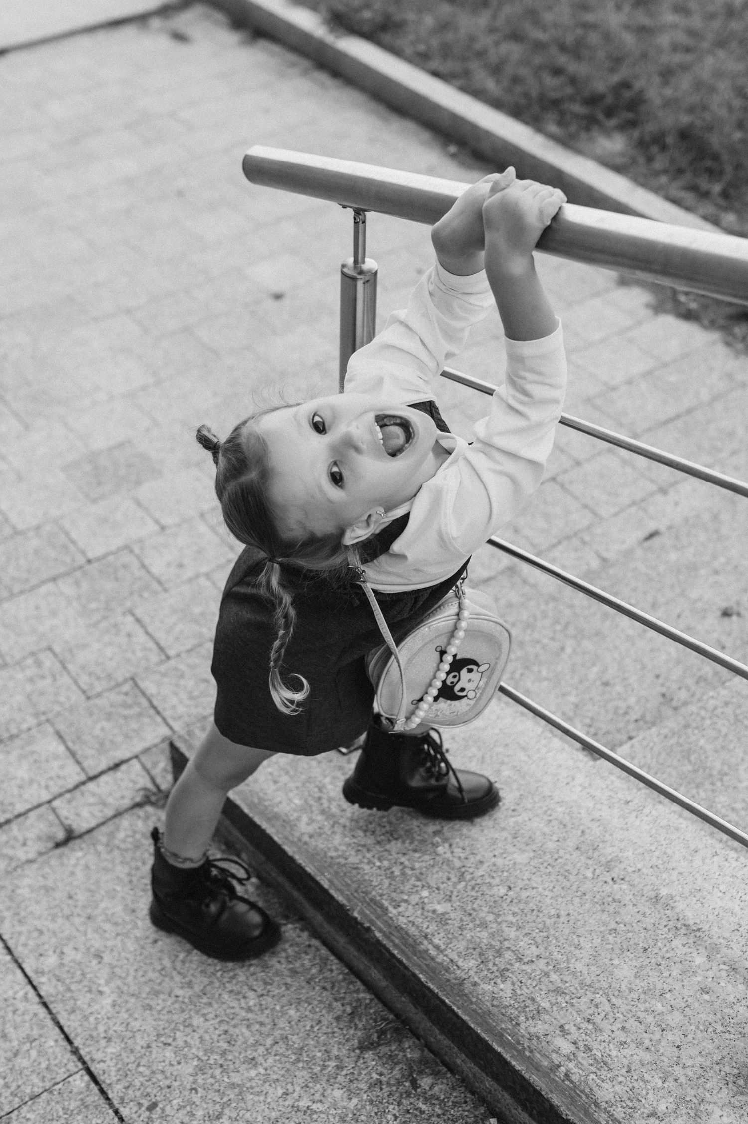 Playful movements captured on concrete steps in black and white photography.