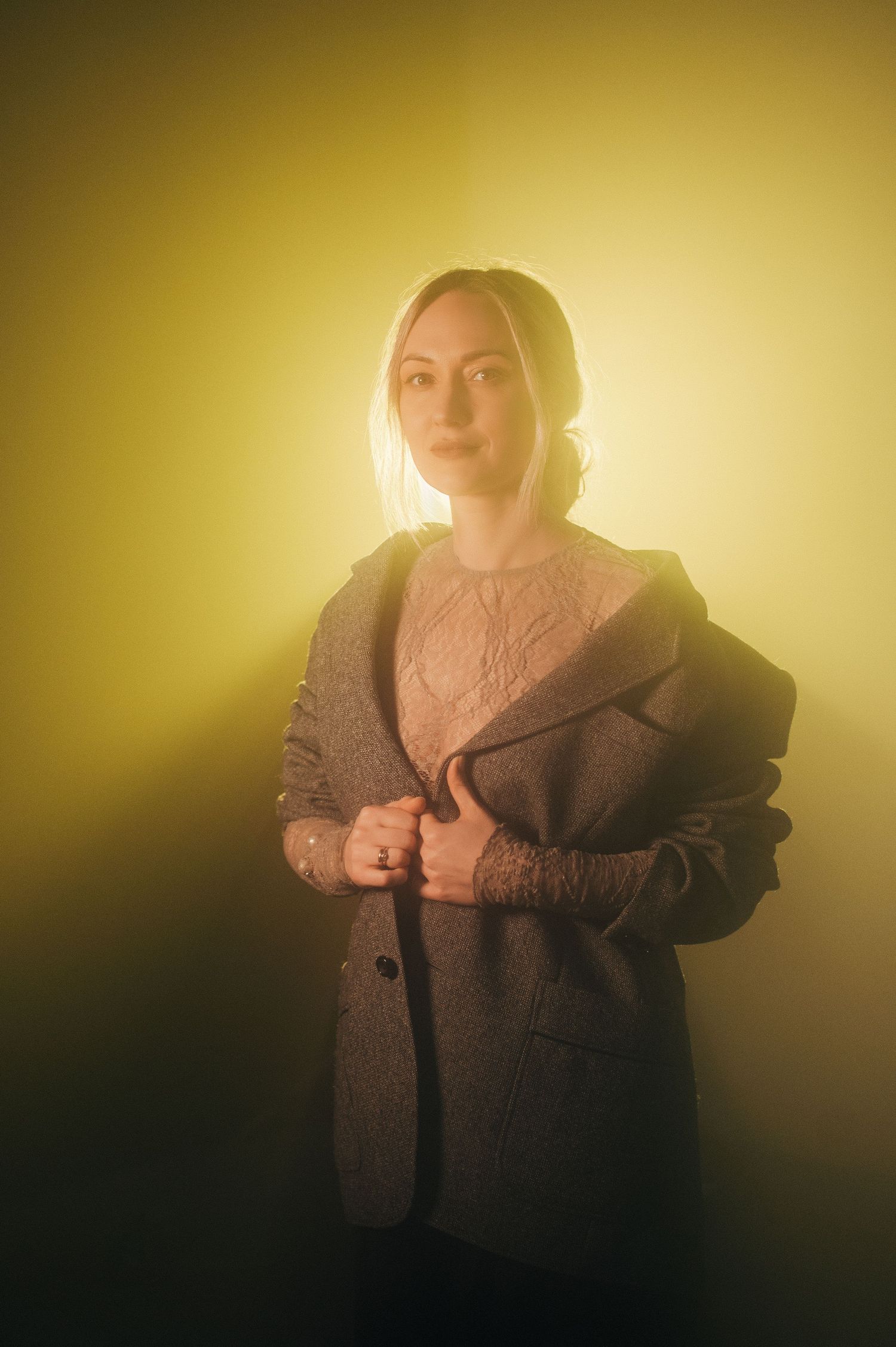 Artistic portraits in golden light showing person in brown coat with dramatic lighting and shadows.