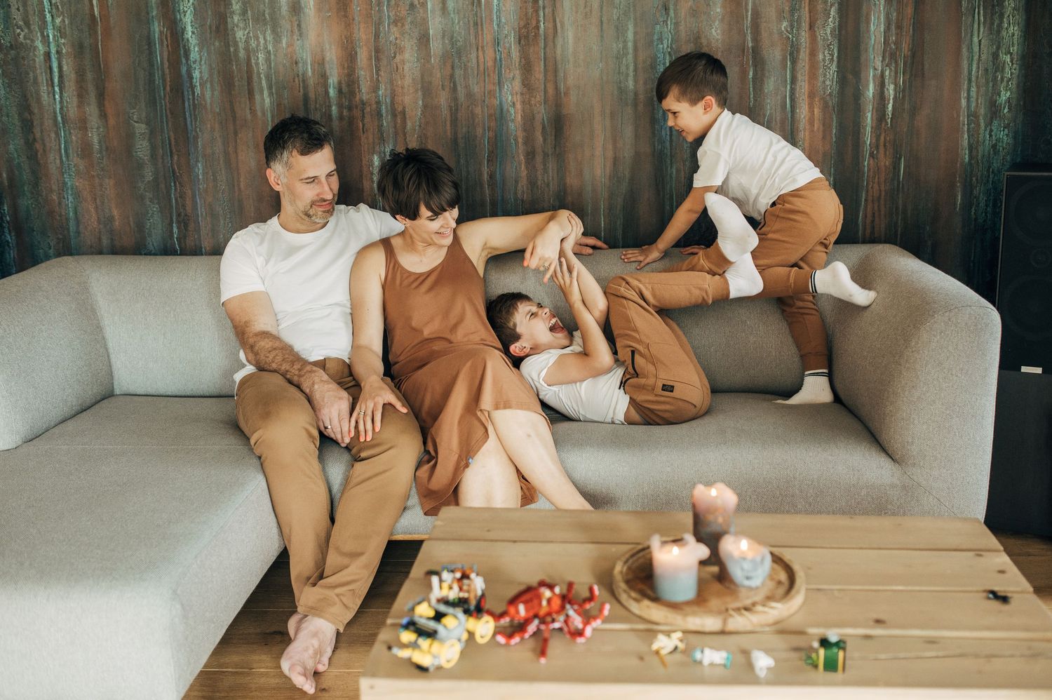 Family members enjoying leisure time together in a living room setting.