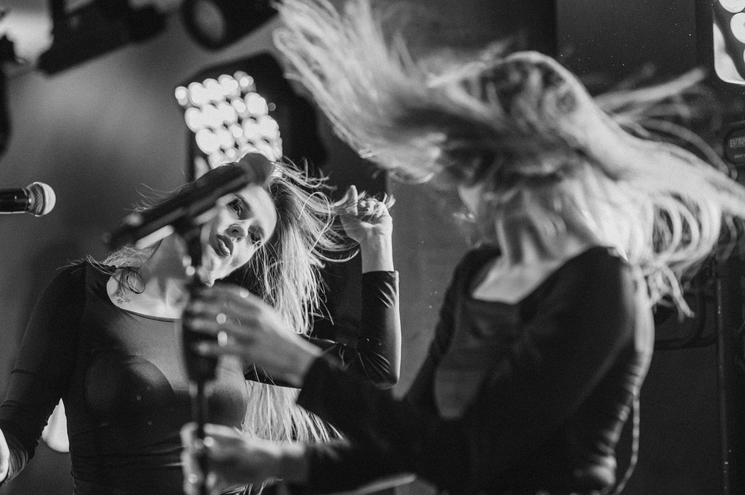 A black and white collage of people dancing and moving energetically at what appears to be a concert or party.