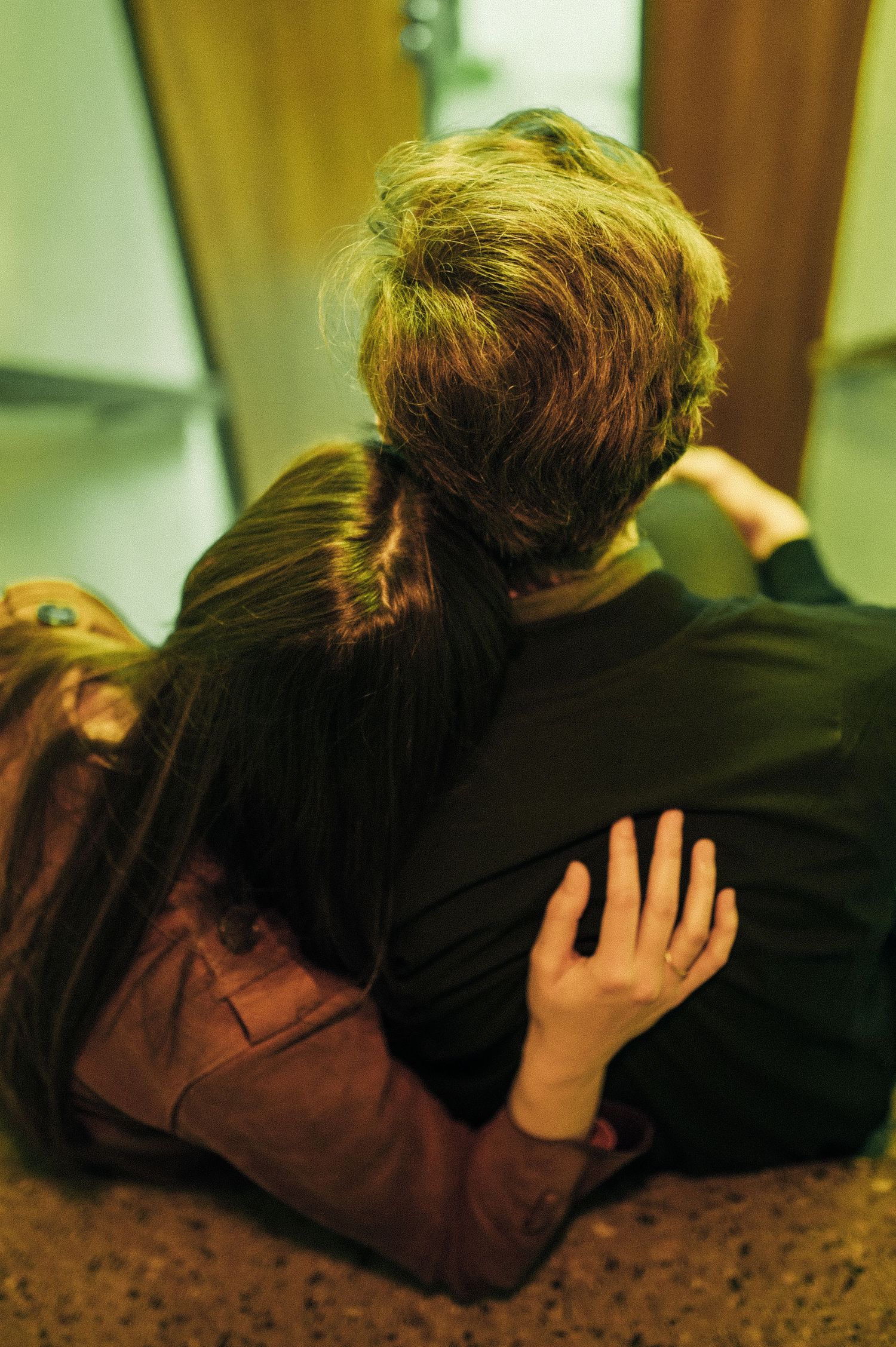 Intimate close-up shots showing tender moments between two people on a dark background.