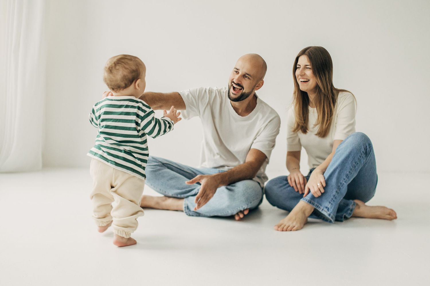 Casual family moments captured on floor showing interaction and play in natural light setting.