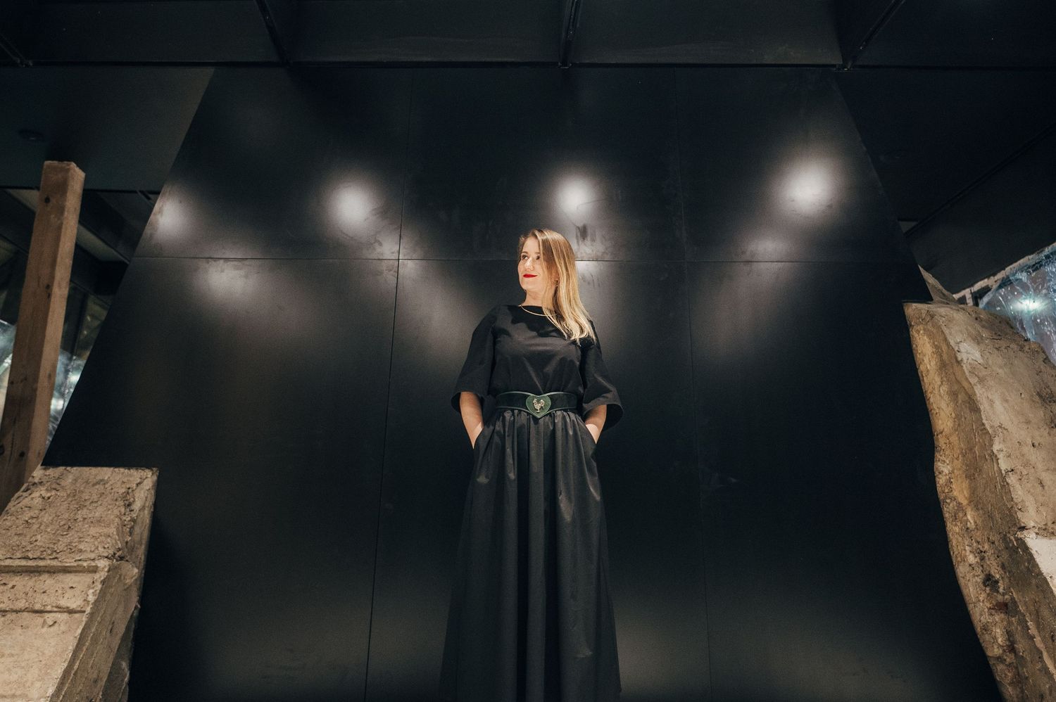 Dramatic fashion shoot with moody lighting and theatrical black dress.