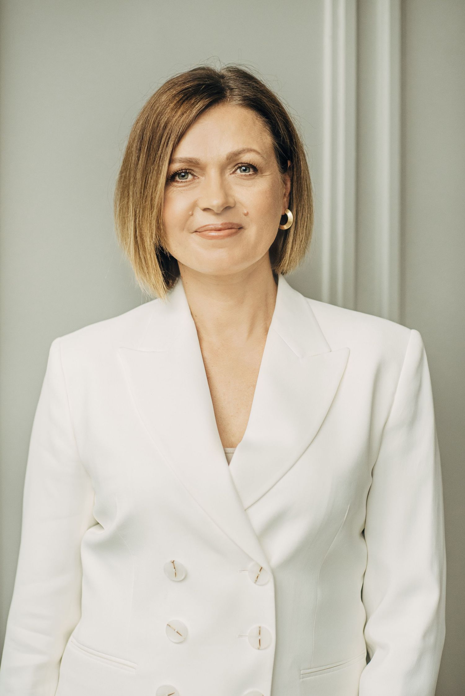 Professional headshots featuring a stylish white blazer against a light neutral background.