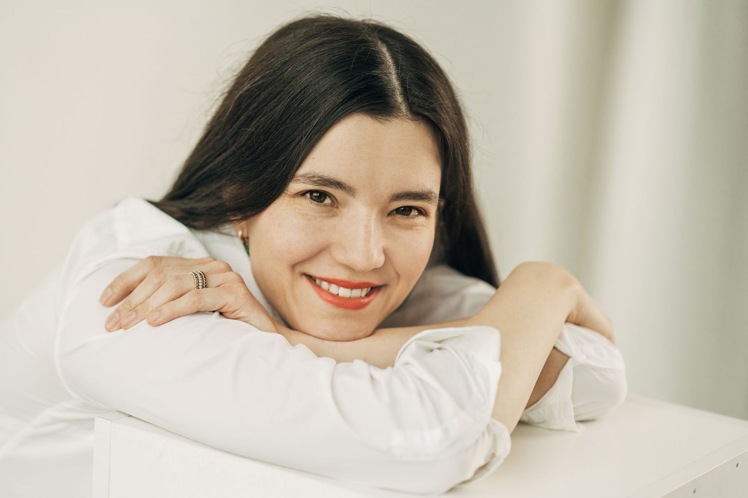 Simple portraits showing genuine smiles and relaxed poses in white shirt.