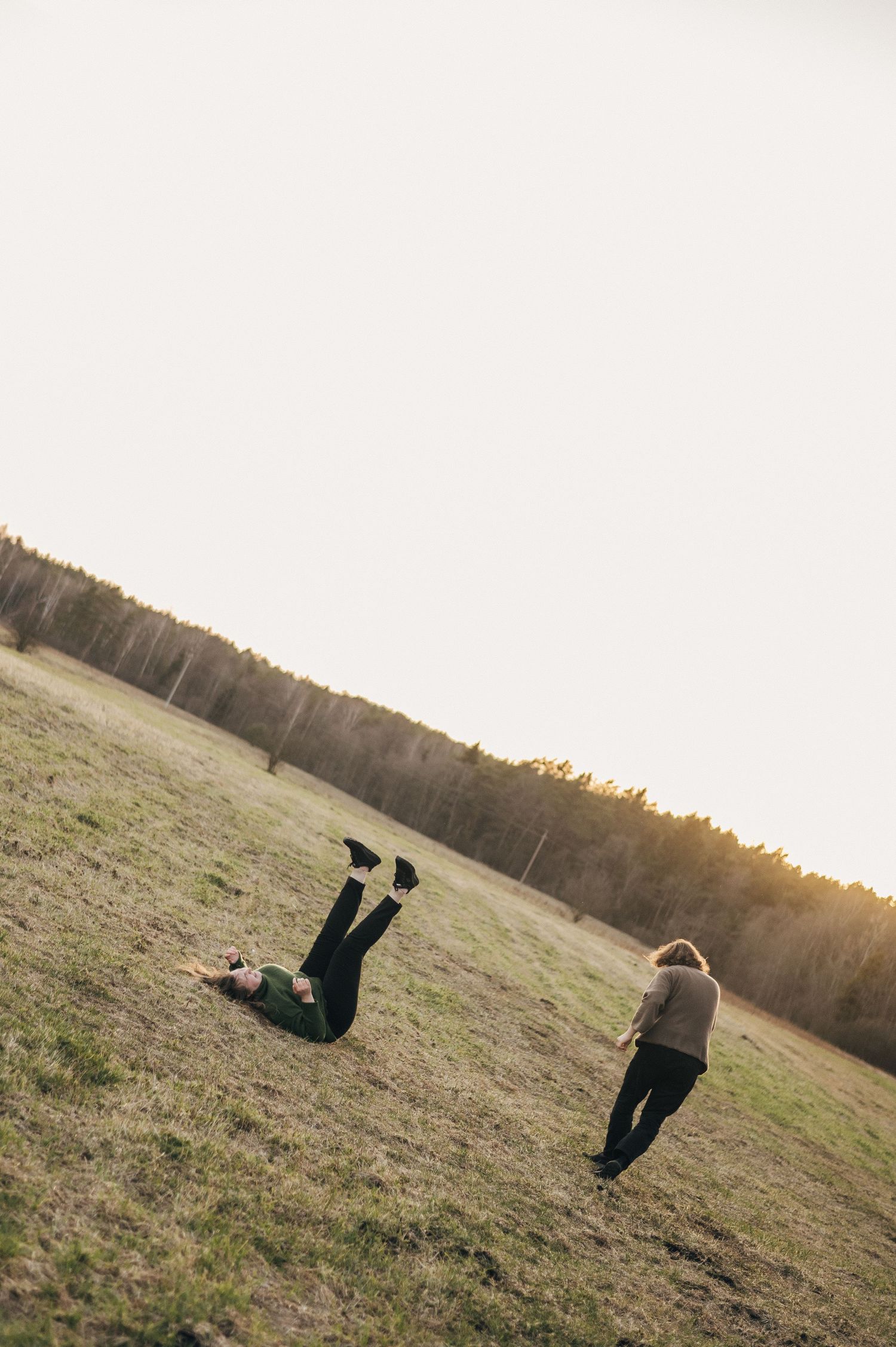 Artistic sequence of someone jumping and floating against minimalist landscape at sunset.