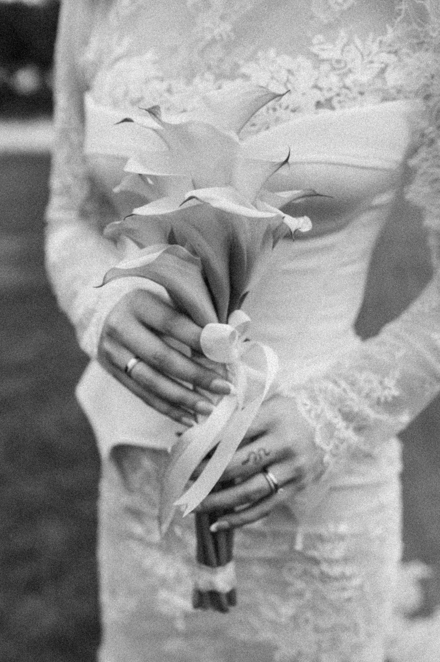 A series of black and white photographs showing hands holding a delicate white wedding bouquet.