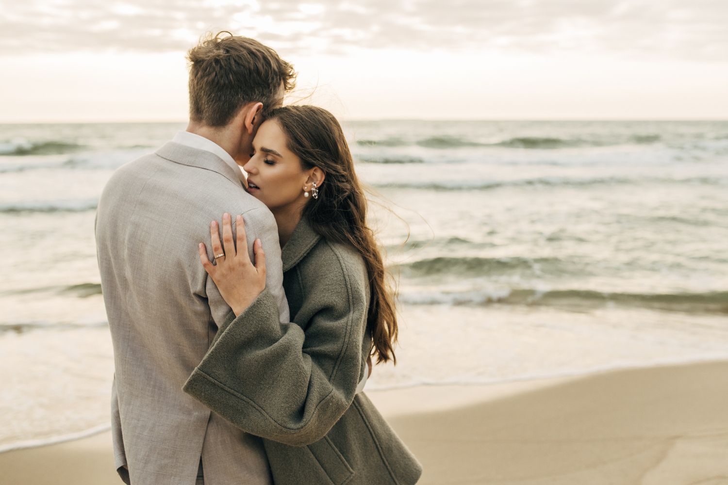 Romantic beach photoshoot with gentle waves and soft natural lighting.