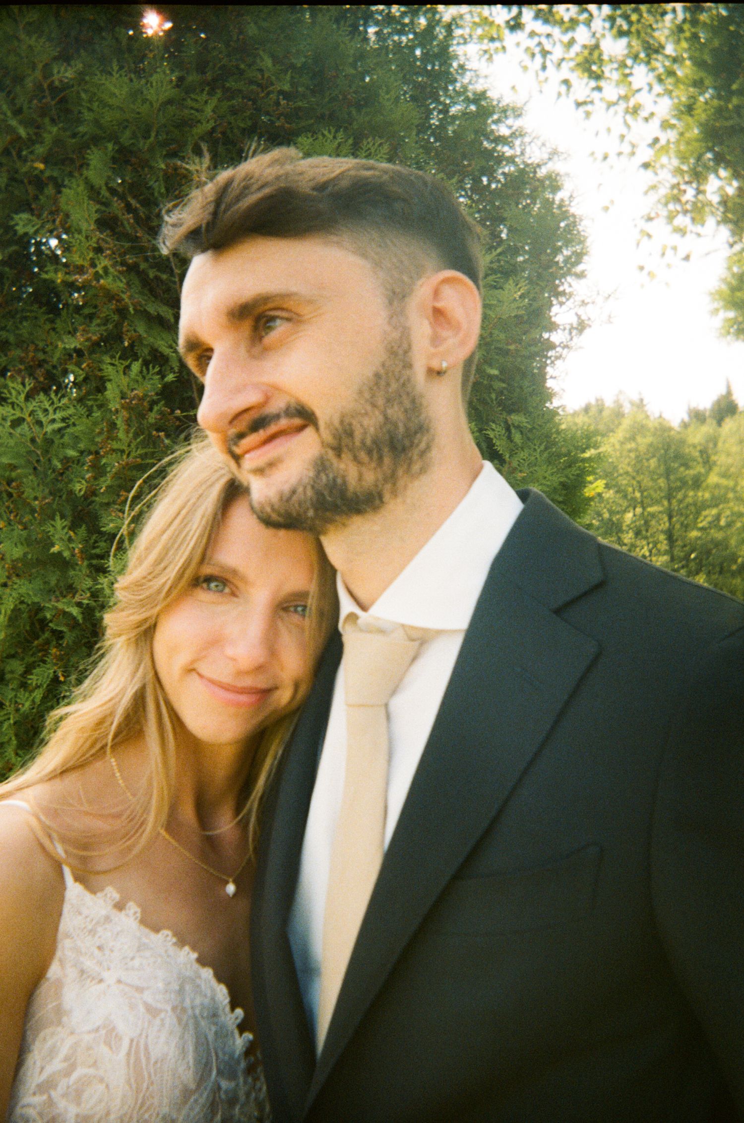 Close-up romantic portraits in warm sunlight with natural outdoor backdrop.