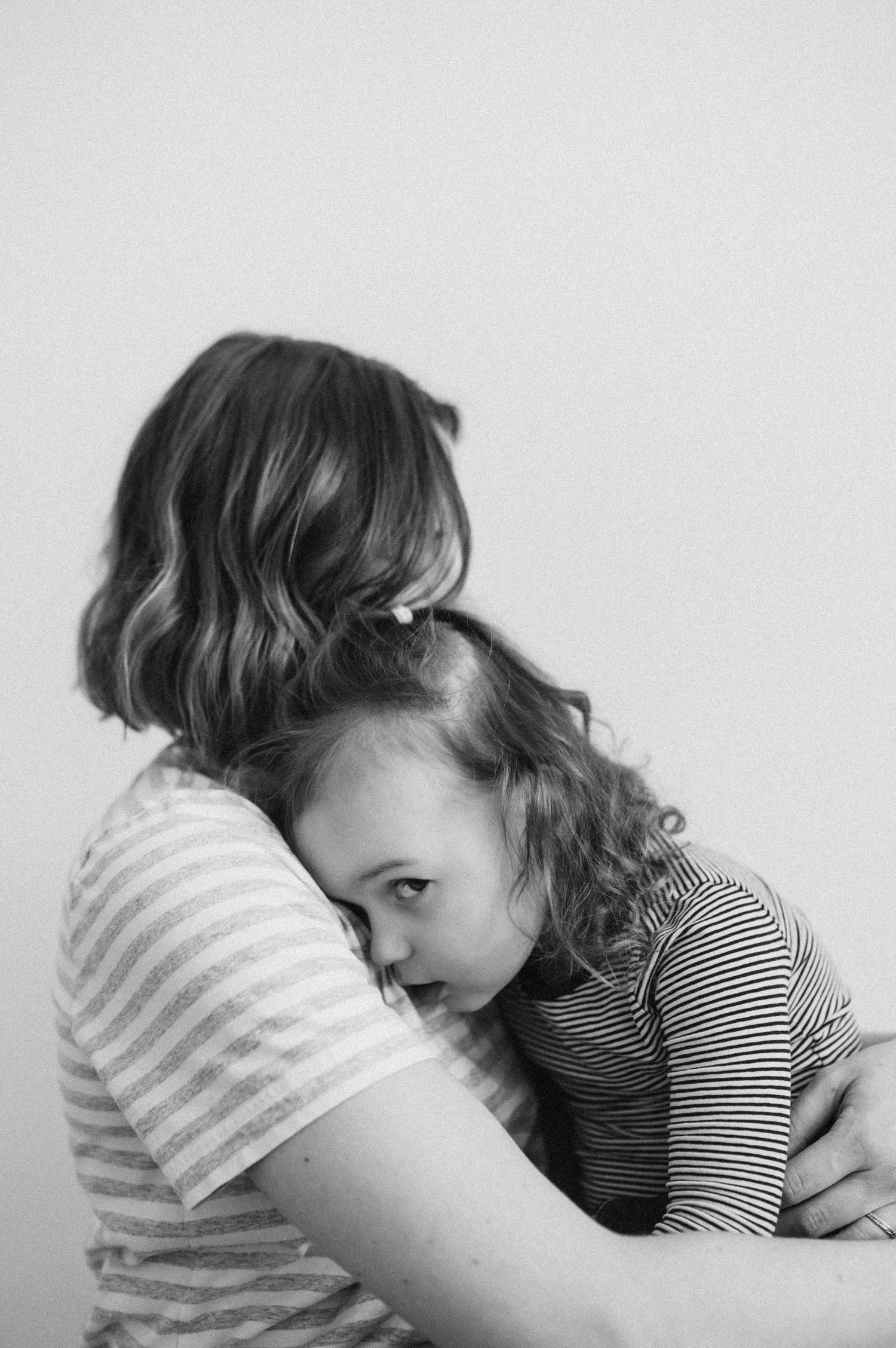 Black and white photo series showing intimate moments of affection and connection.