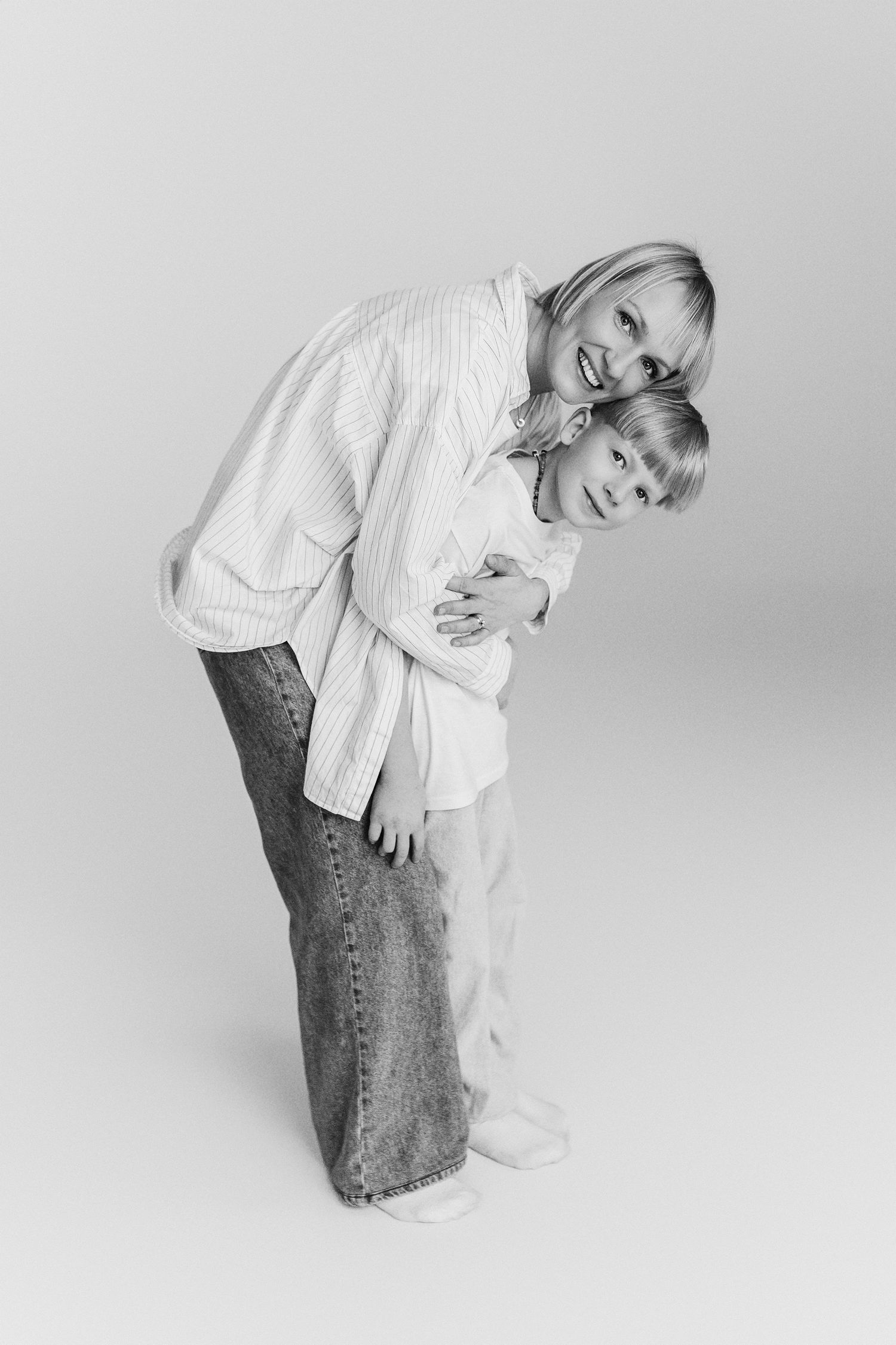 A series of four black and white photos showing someone in jeans and white shirt bending over in progressive sequence.