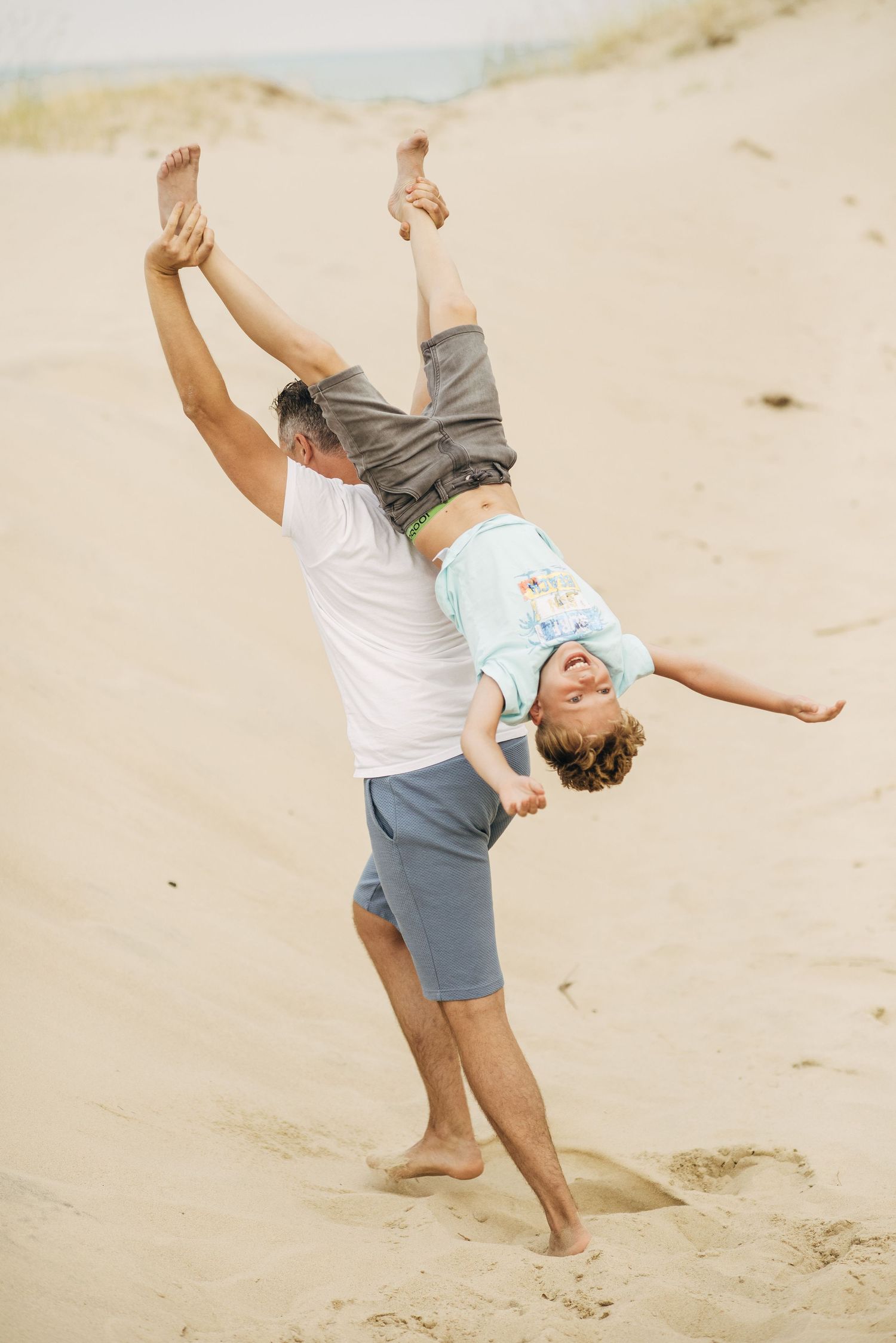 Dancing and spinning on a sandy beach in joyful carefree moments.