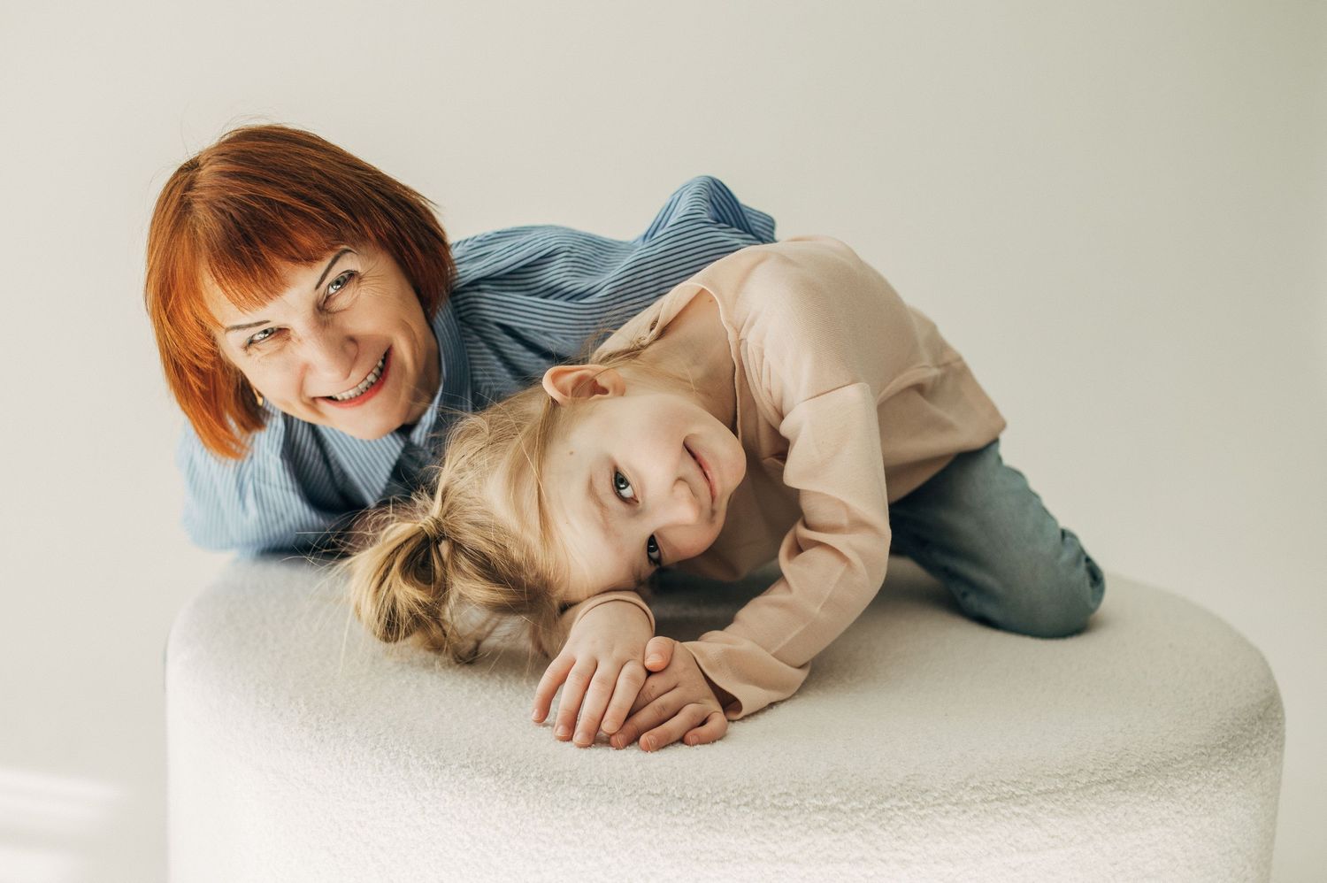 Relaxed studio portraits showing family members lounging together in casual attire.