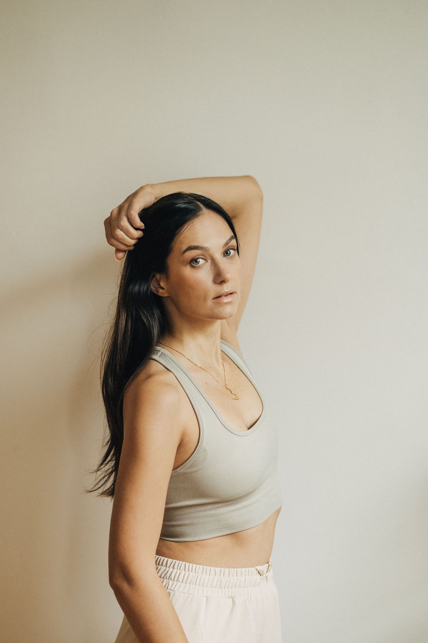 Artistic portrait series showing dance movements in neutral tones against white wall.