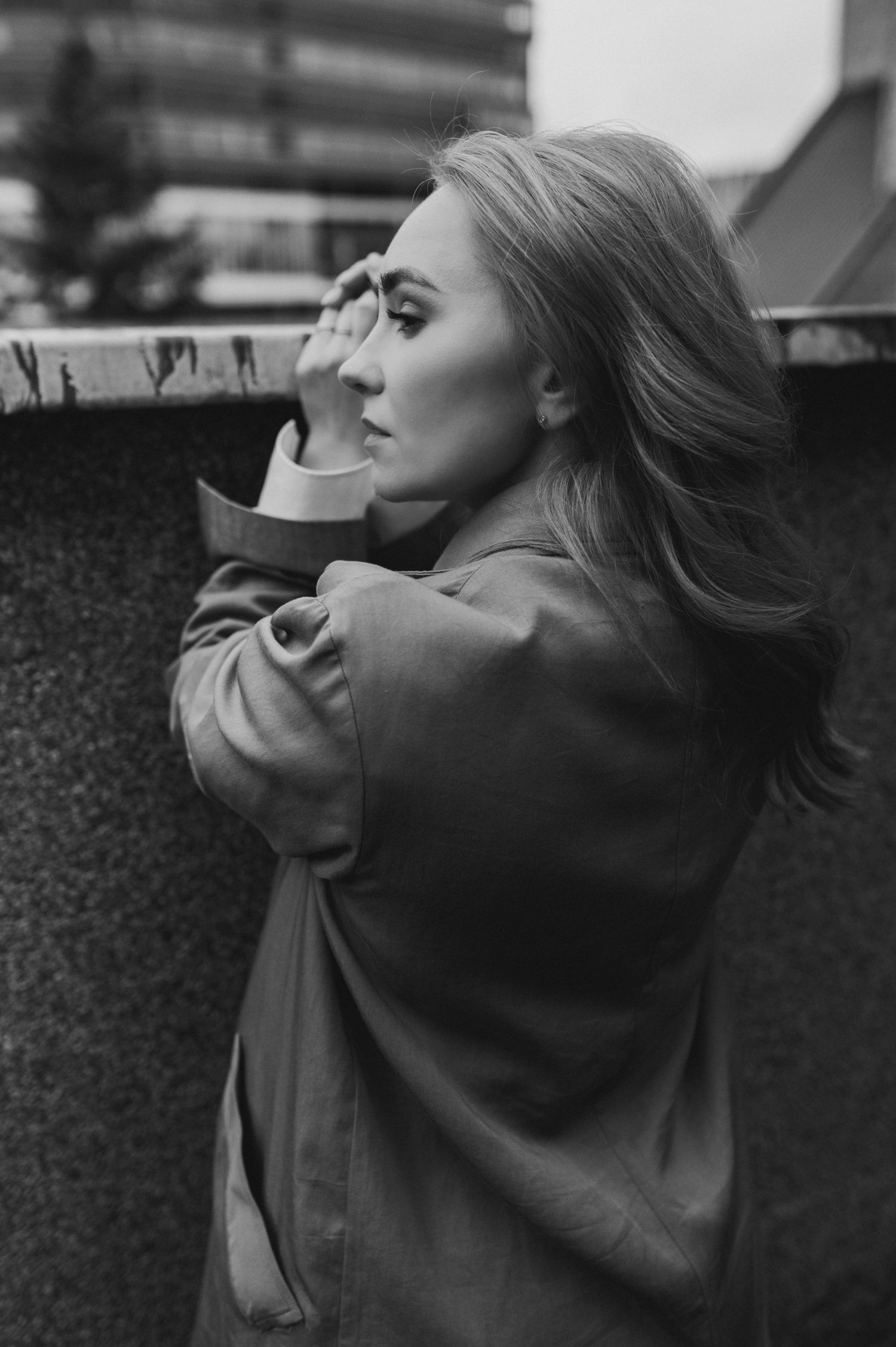 Artistic black and white profile portrait in moody lighting.