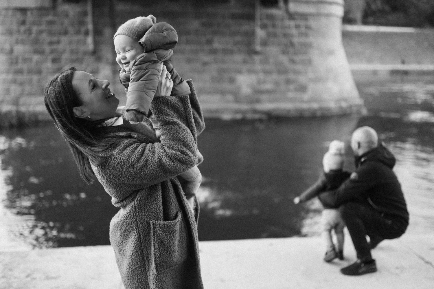 A series of black and white photographs showing people interacting near a brick wall.