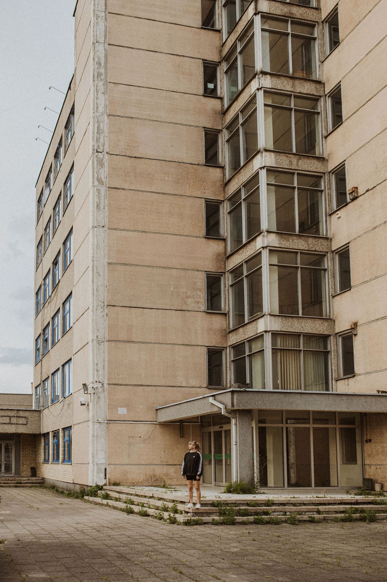 Brutalist concrete apartment building exterior with a geometric facade and angular architecture.