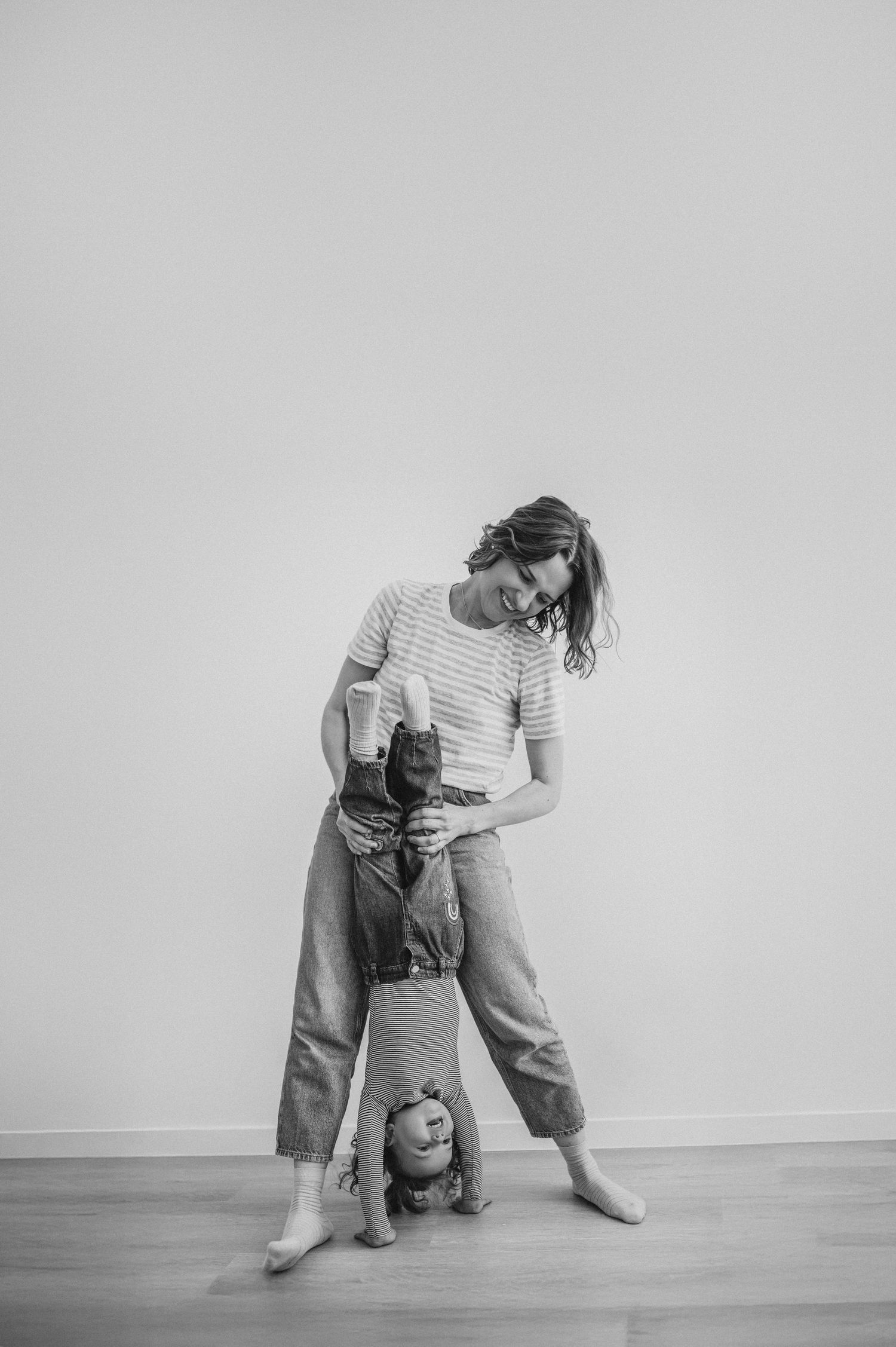 Black and white photos showing playful interactions and movement against a white wall.