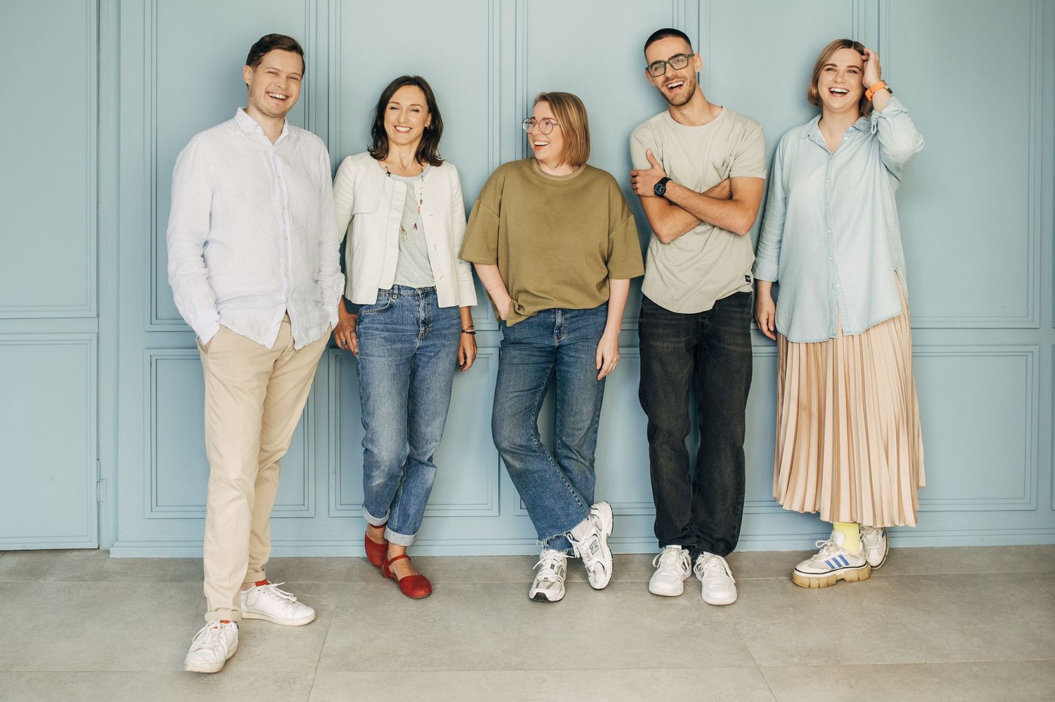 Lifestyle group photos against light blue walls showing casual coordinated outfits.