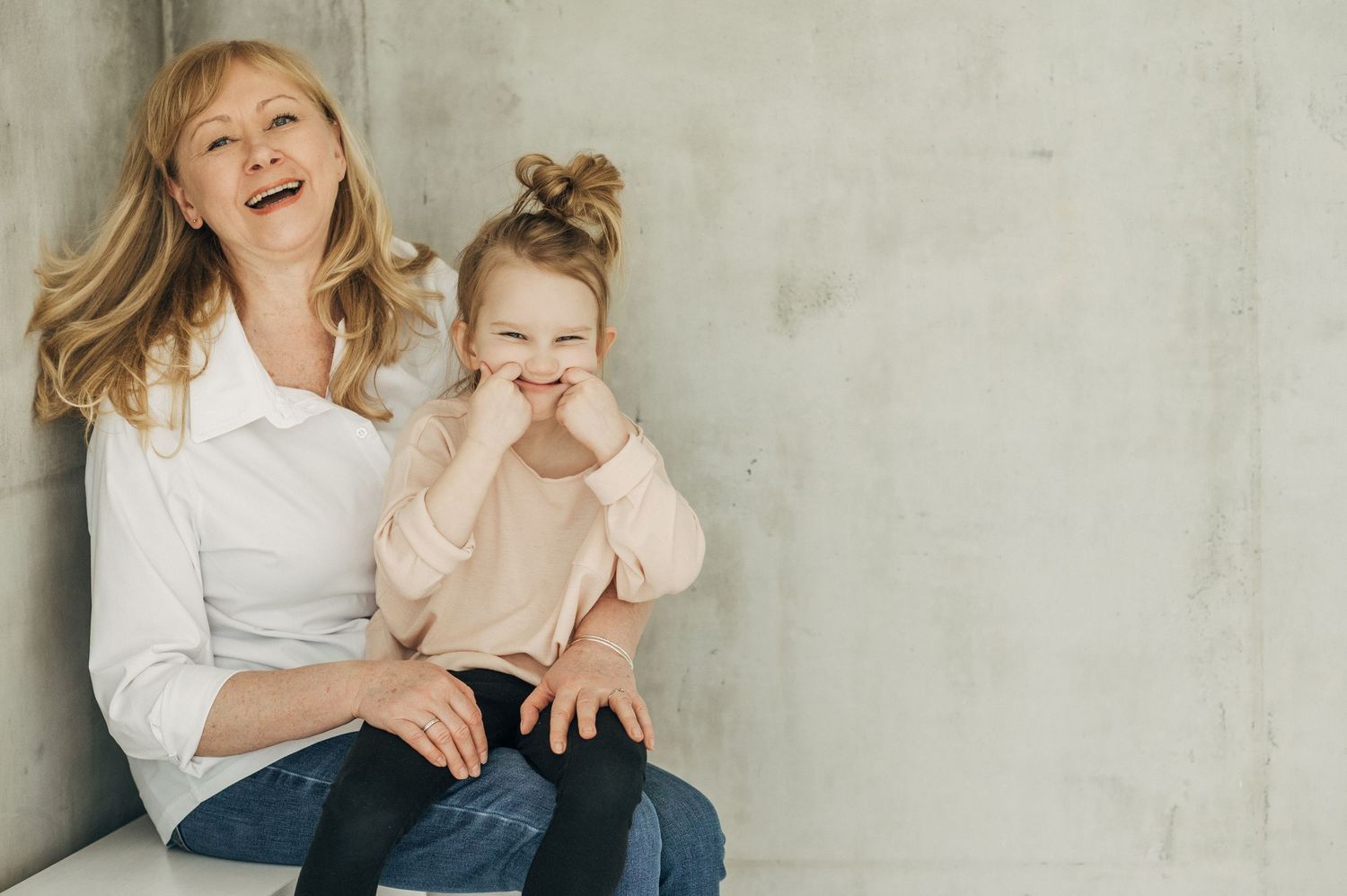Candid family photo series showing natural moments and expressions against neutral background.