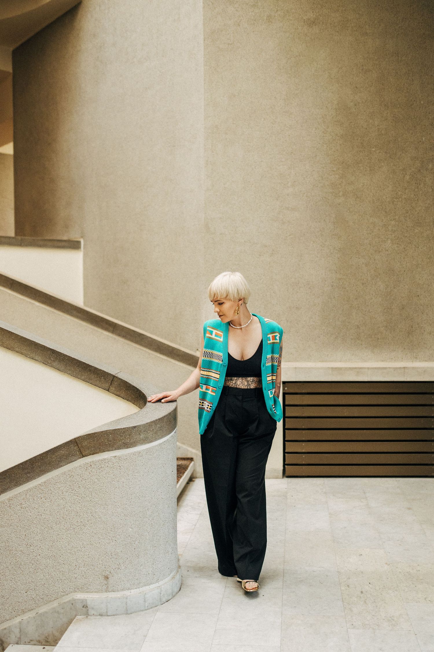 Architectural fashion photography featuring curved concrete walls and minimalist design.