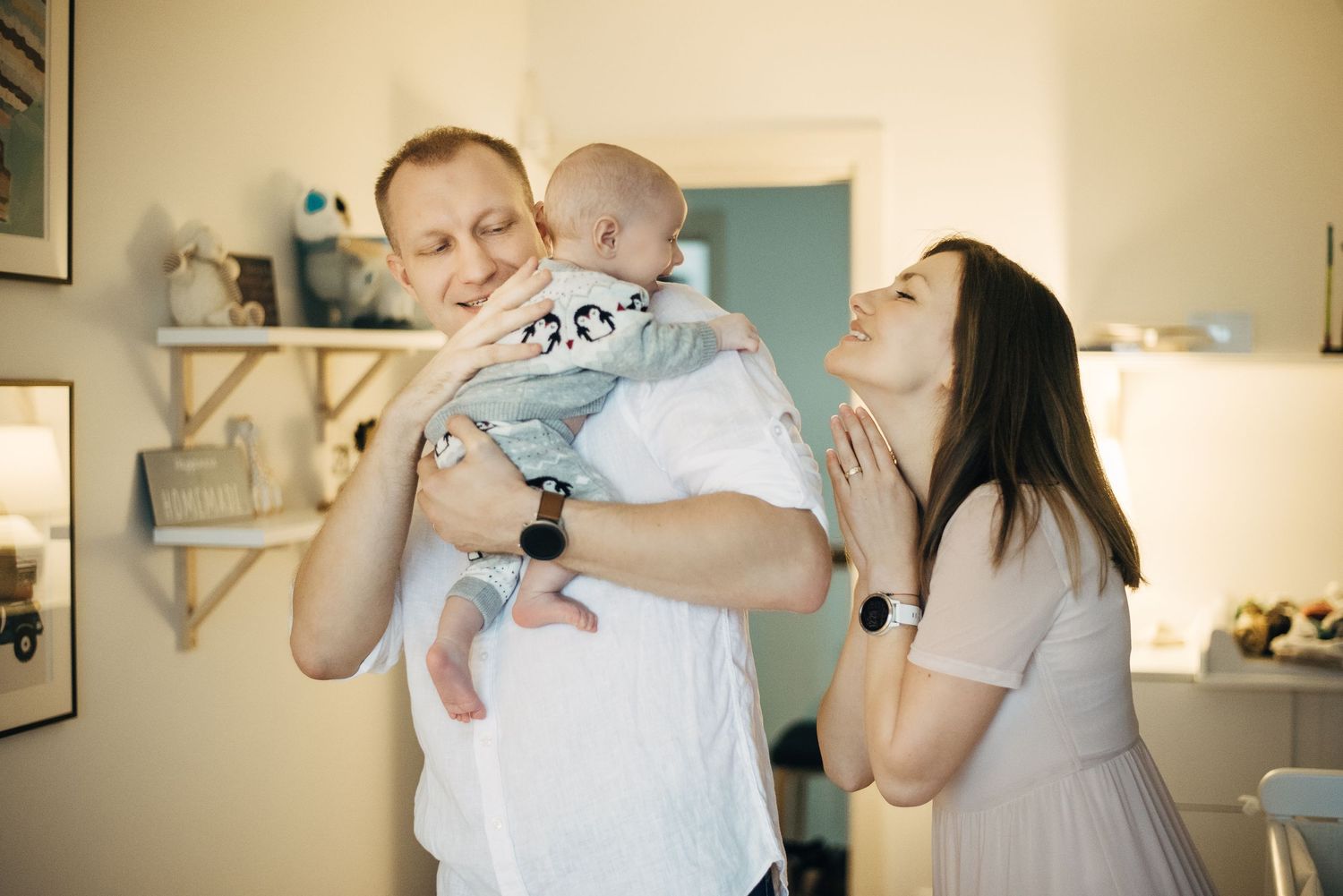 Family in white outfits playing together at home.