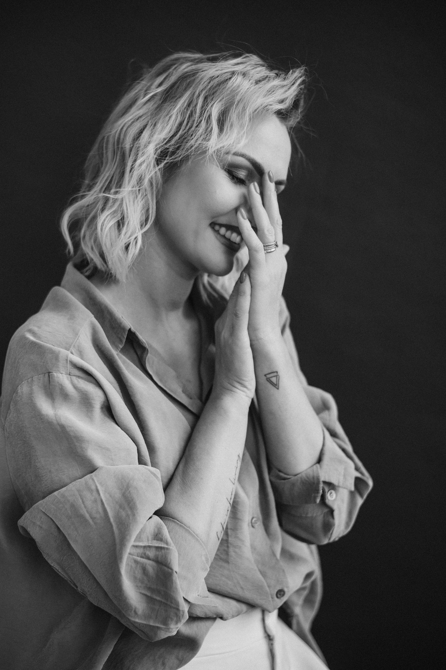 Dramatic black and white portrait series showing emotive poses in soft lighting.