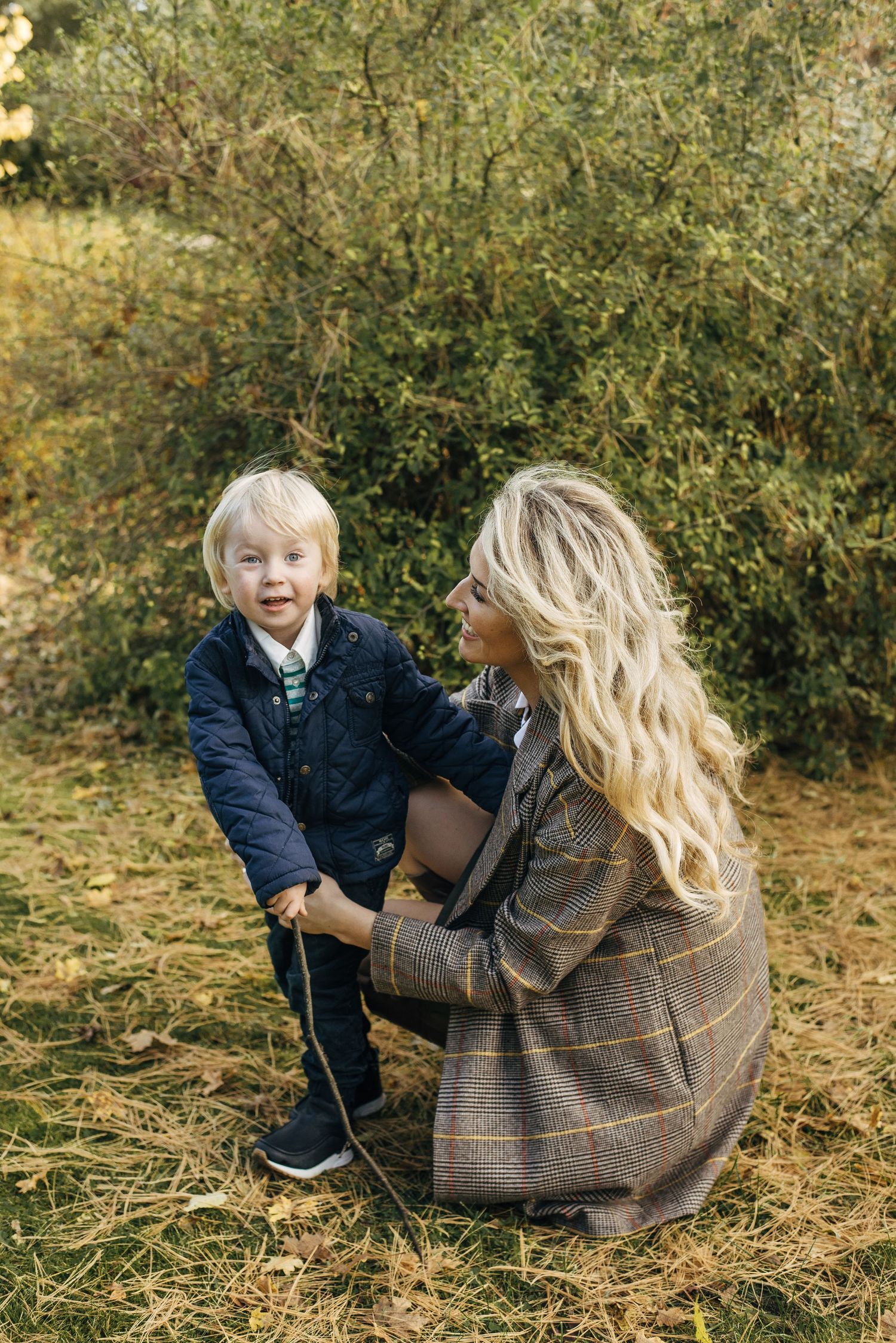 Heartwarming autumn scene of parent and child interaction outdoors.