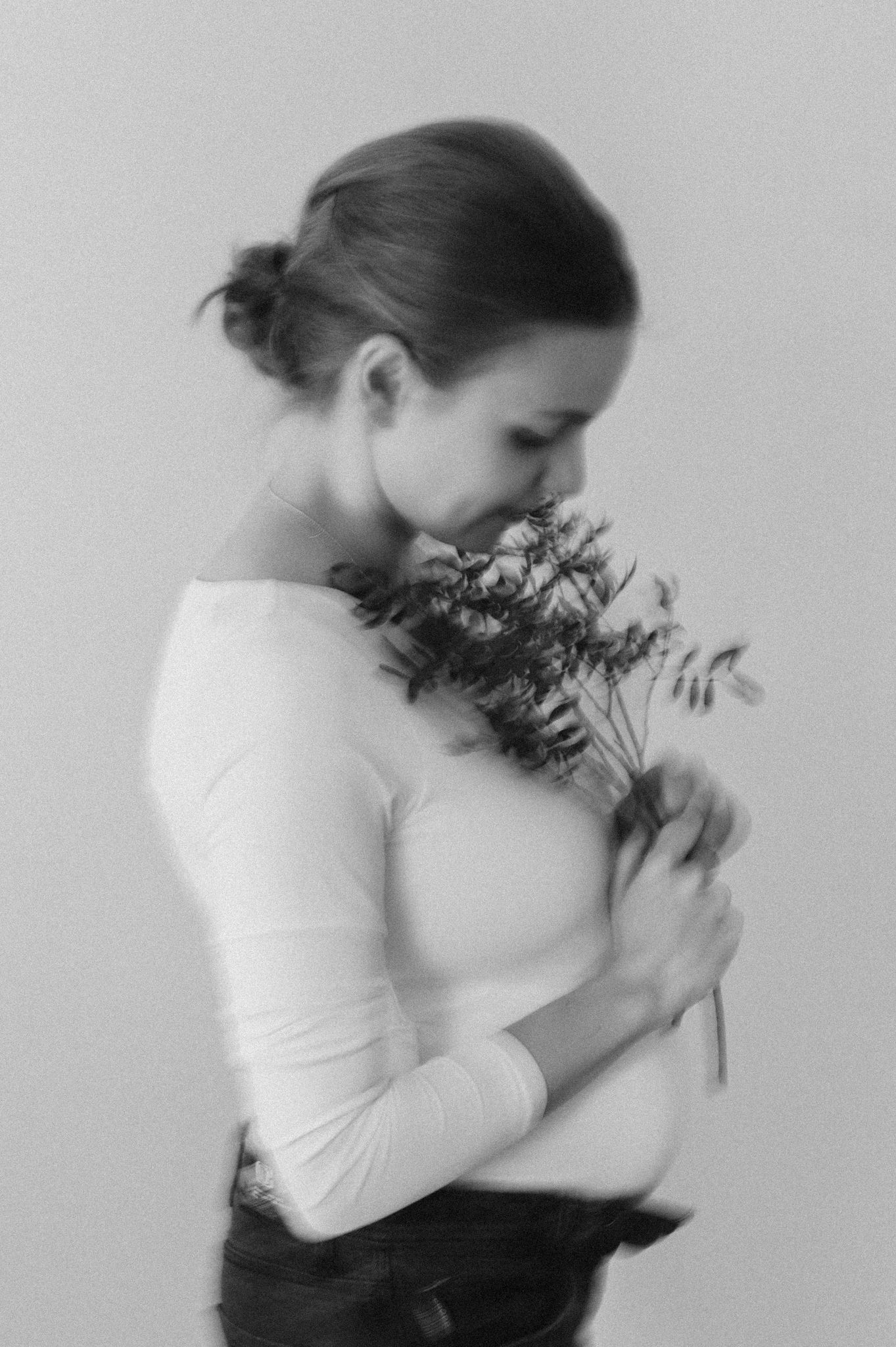Black and white sequence showing a person in motion with flowers creating an artistic blur effect.