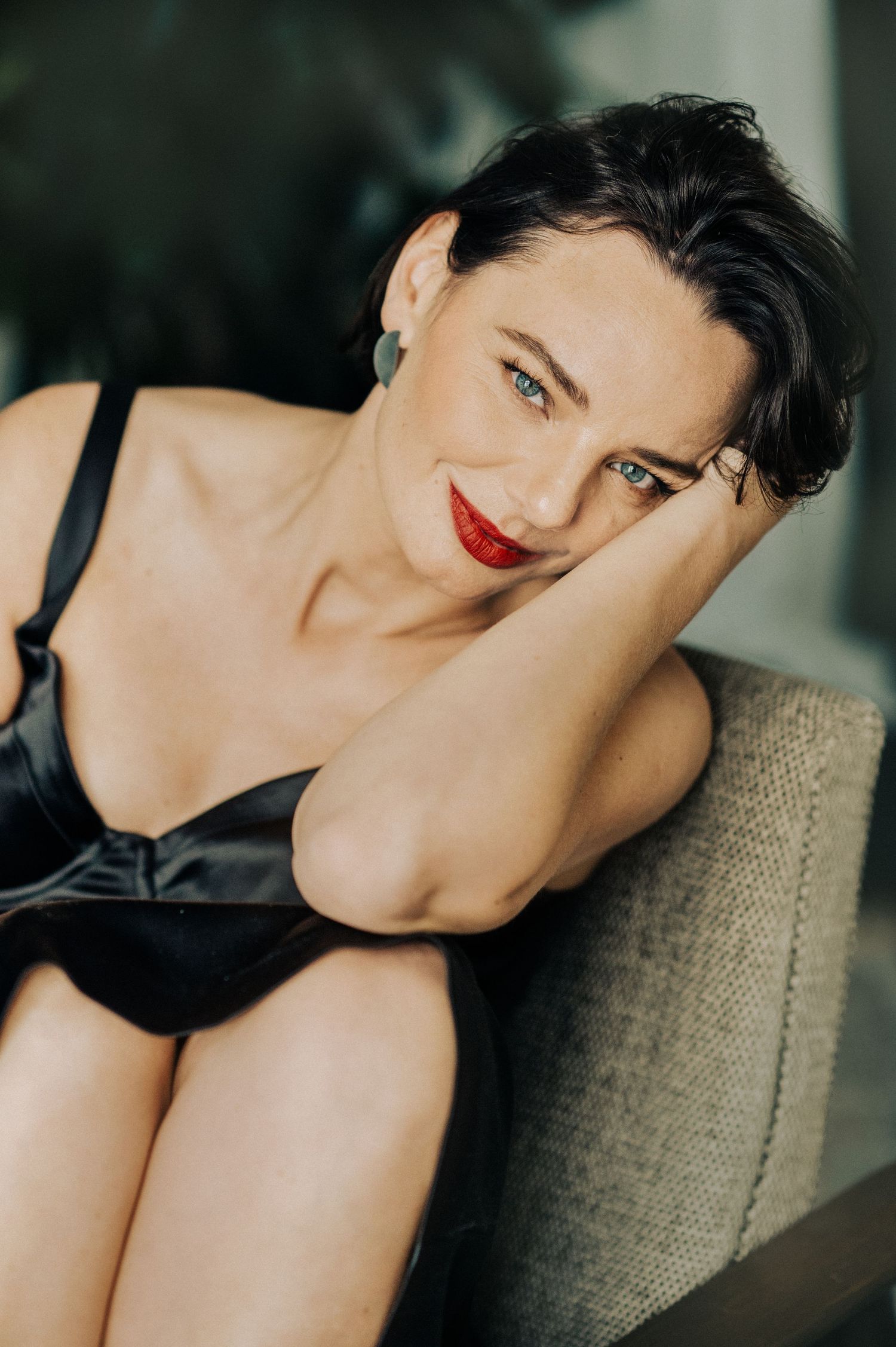 Artistic photo series featuring model in black attire on textured chair.