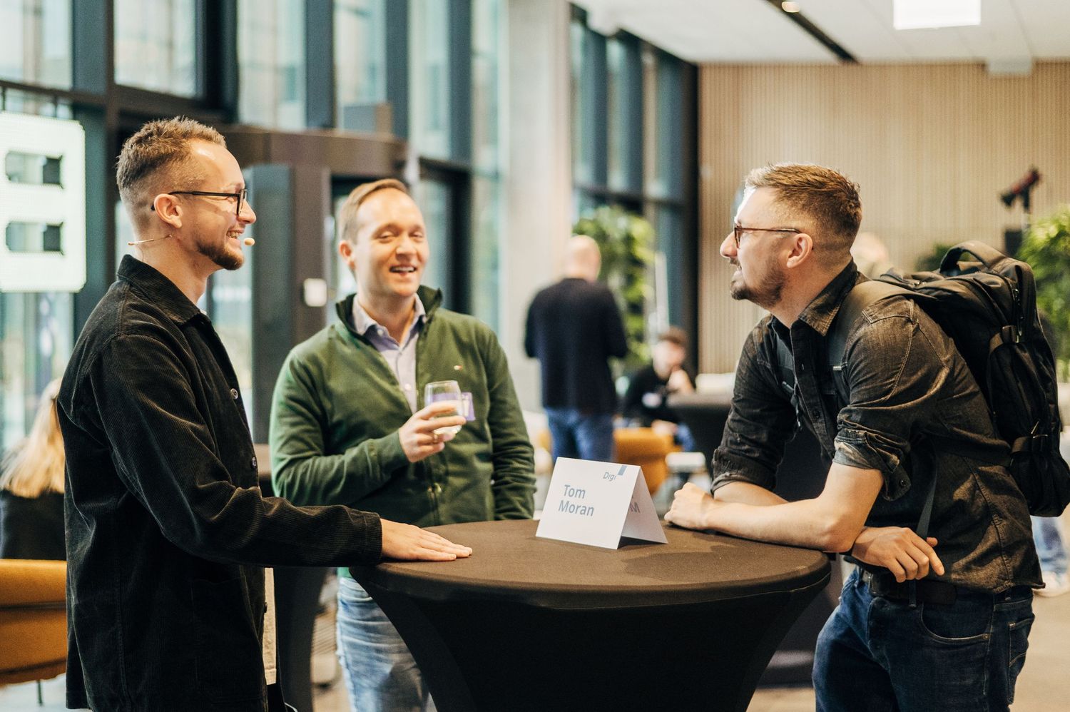 Business professionals collaborating and having discussions in a modern office space.